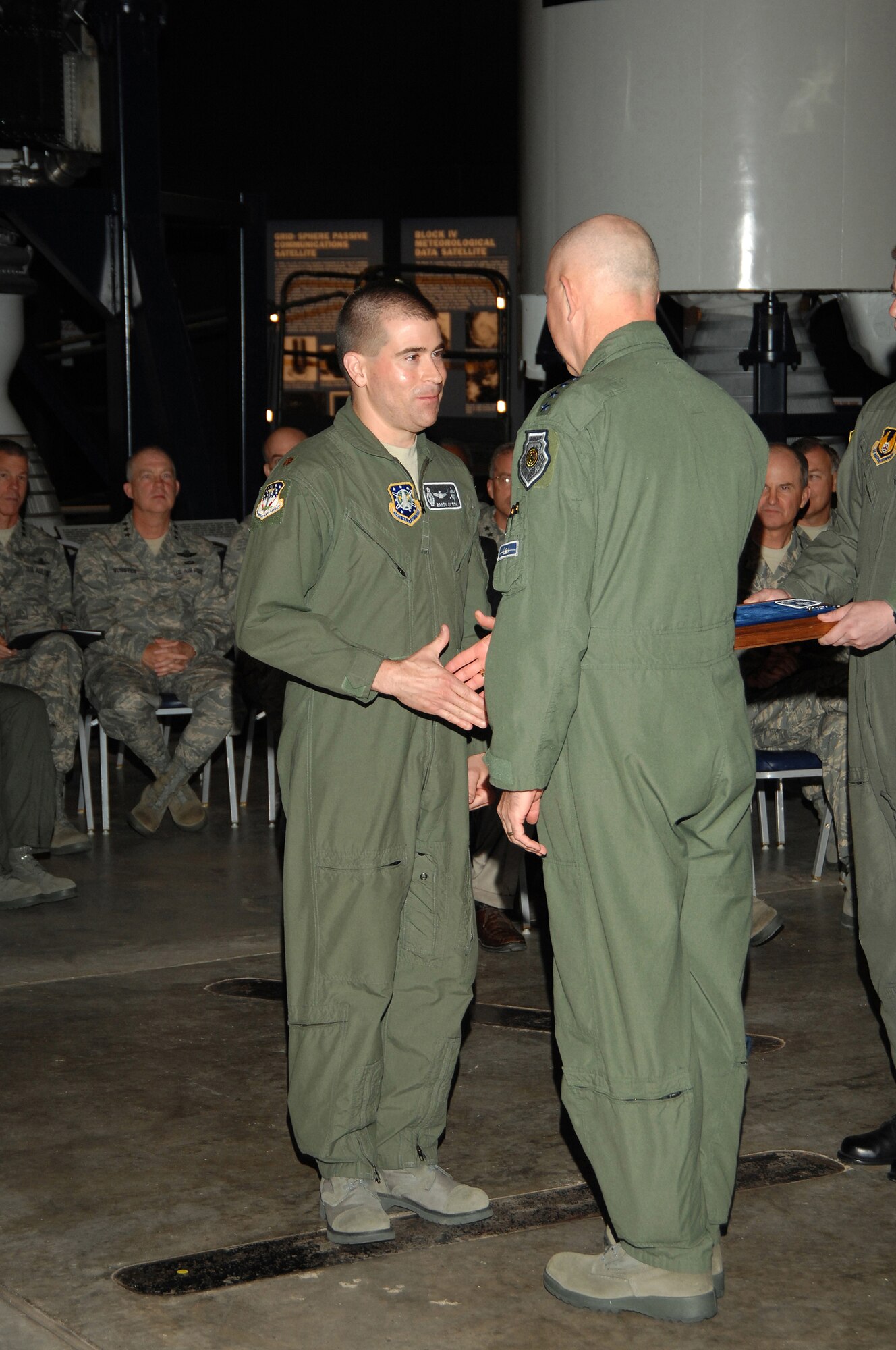 Missile badge recipient Maj. Randy Olson thanks Air Force Chief of Staff Gen. T. Michael Moseley. Major Olson is assigned to the 341st Space Wing at Malmstrom Air Force Base, Mont. He was one of 14 officers who received his missile badge during a Peacekeeper Missile dedication ceremony at the National Museum of the United States Air Force June 6. (U.S. Air Force photo/Ben Strasser) 