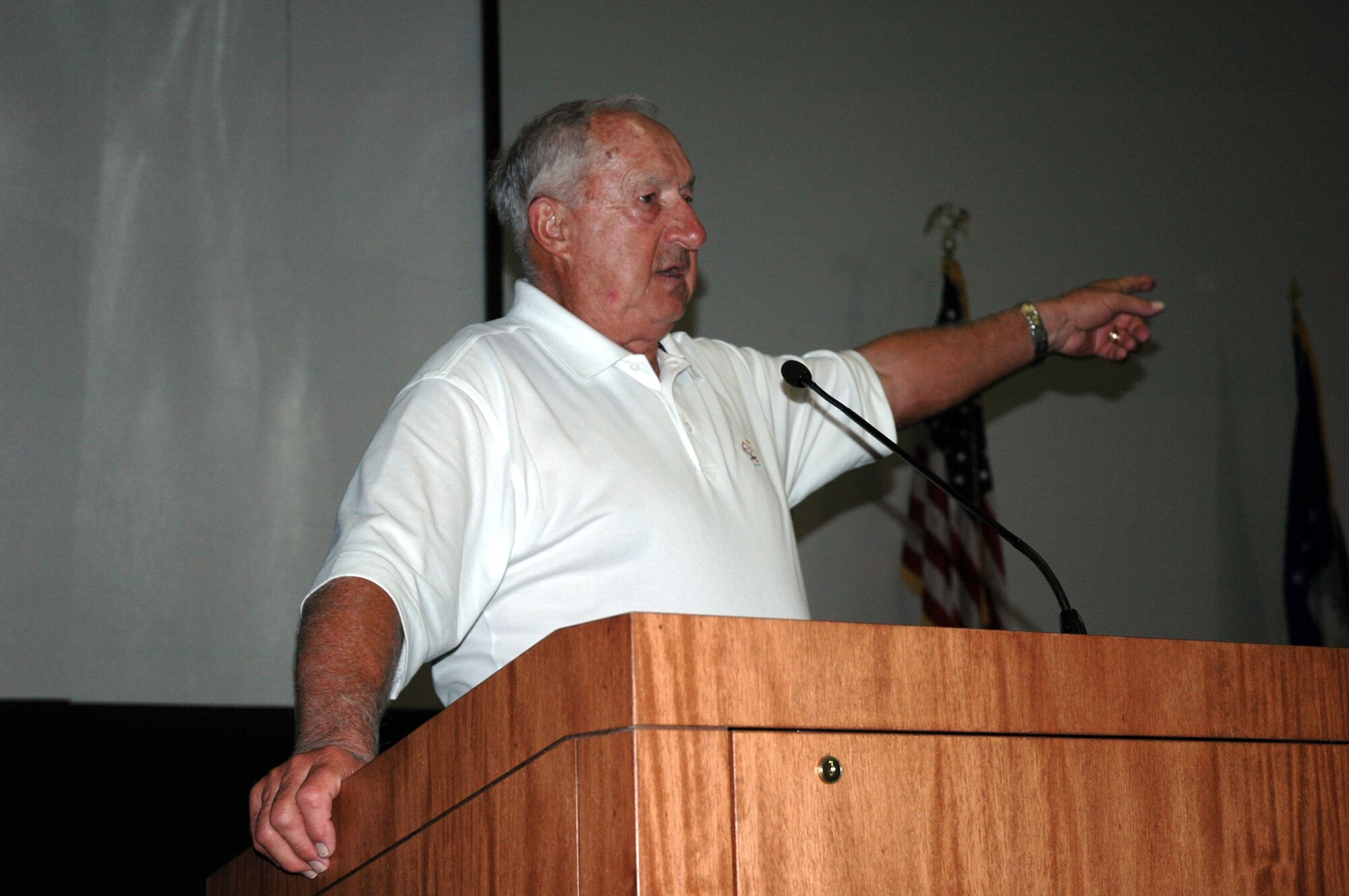 Edmund "Zeke" Bratkowski, a former all-star NFL quarterback for the University of Georgia, Chicago Bears, Los Angeles Rams and Green Bay Packers, points to the direction of Duke Field's flight line while he describes his efforts to land a drone aircraft there more than 50 years ago as an Air Force director pilot in the 3205th Drone Squadron. Mr. Bratkowski was inducted as an honorary 919th Special Operations Wing Top 3 member June 7. (U.S. Air Force Photo/Jasmine DeNamur)