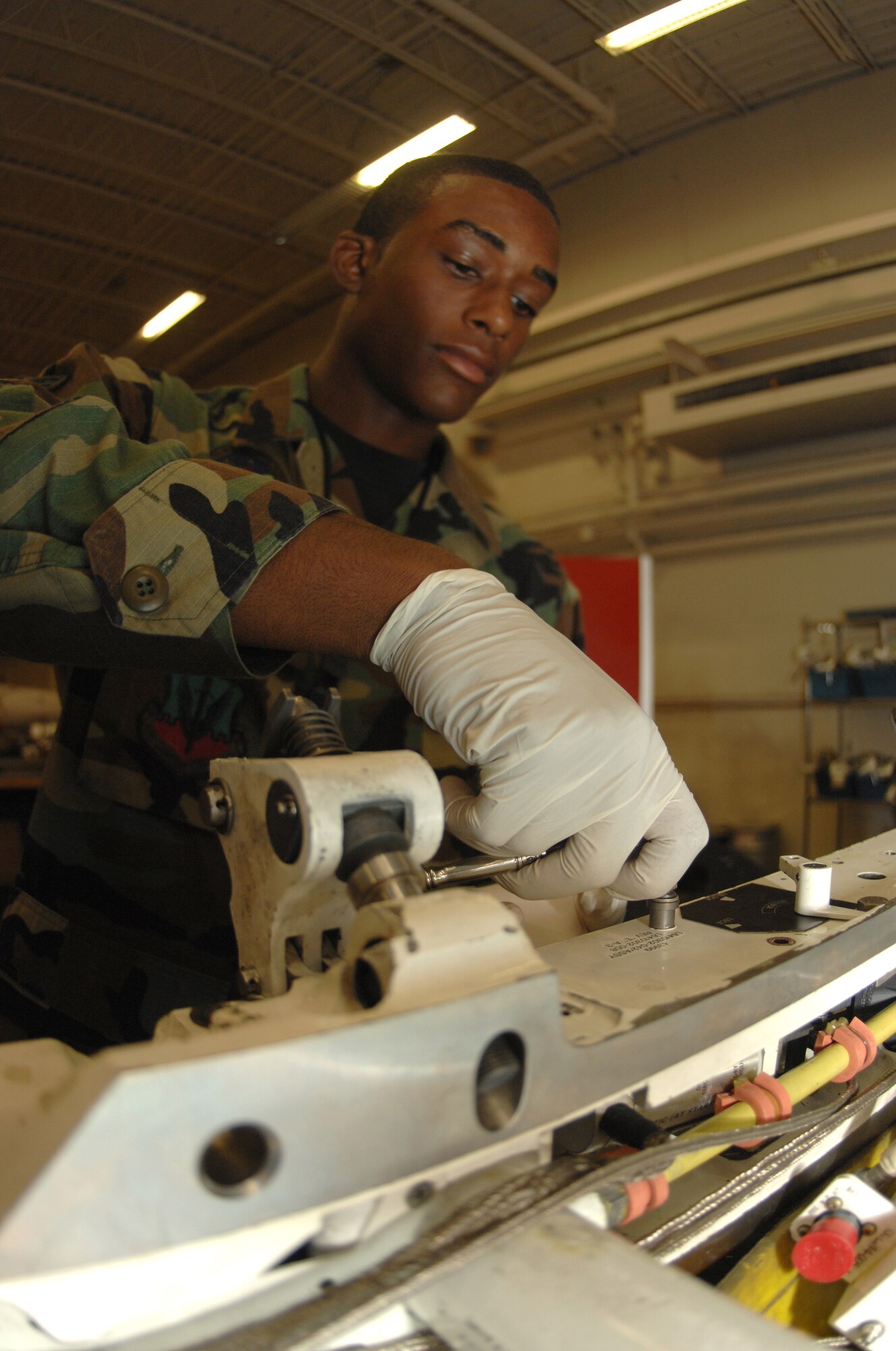 DYESS AIR FORCE BASE, Texas -- Airman 1st Class Nathan Girton, 7th Munitions Squadron, disassembles an ejector rack from one of Dyess's B-1 weapon systems here, June 4.  Airman Girton, along with his fellow maintainers, is responsible for maintaining all weapon systems on Dyess's aircrafts, including digitally analyzing the bombs to ensure the computer can properly read and deploy them in a time of need.  (U.S. Air Force photo/Airman 1st Class Jennifer Romig)