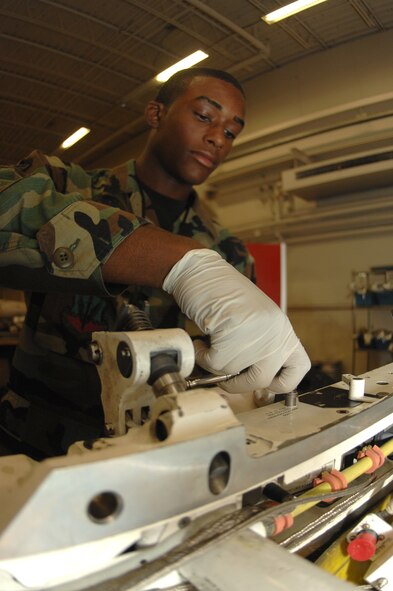 DYESS AIR FORCE BASE, Texas -- Airman 1st Class Nathan Girton, 7th Munitions Squadron, disassembles an ejector rack from one of Dyess's B-1 weapon systems here, June 4.  Airman Girton, along with his fellow maintainers, is responsible for maintaining all weapon systems on Dyess's aircrafts, including digitally analyzing the bombs to ensure the computer can properly read and deploy them in a time of need.  (U.S. Air Force photo/Airman 1st Class Jennifer Romig)