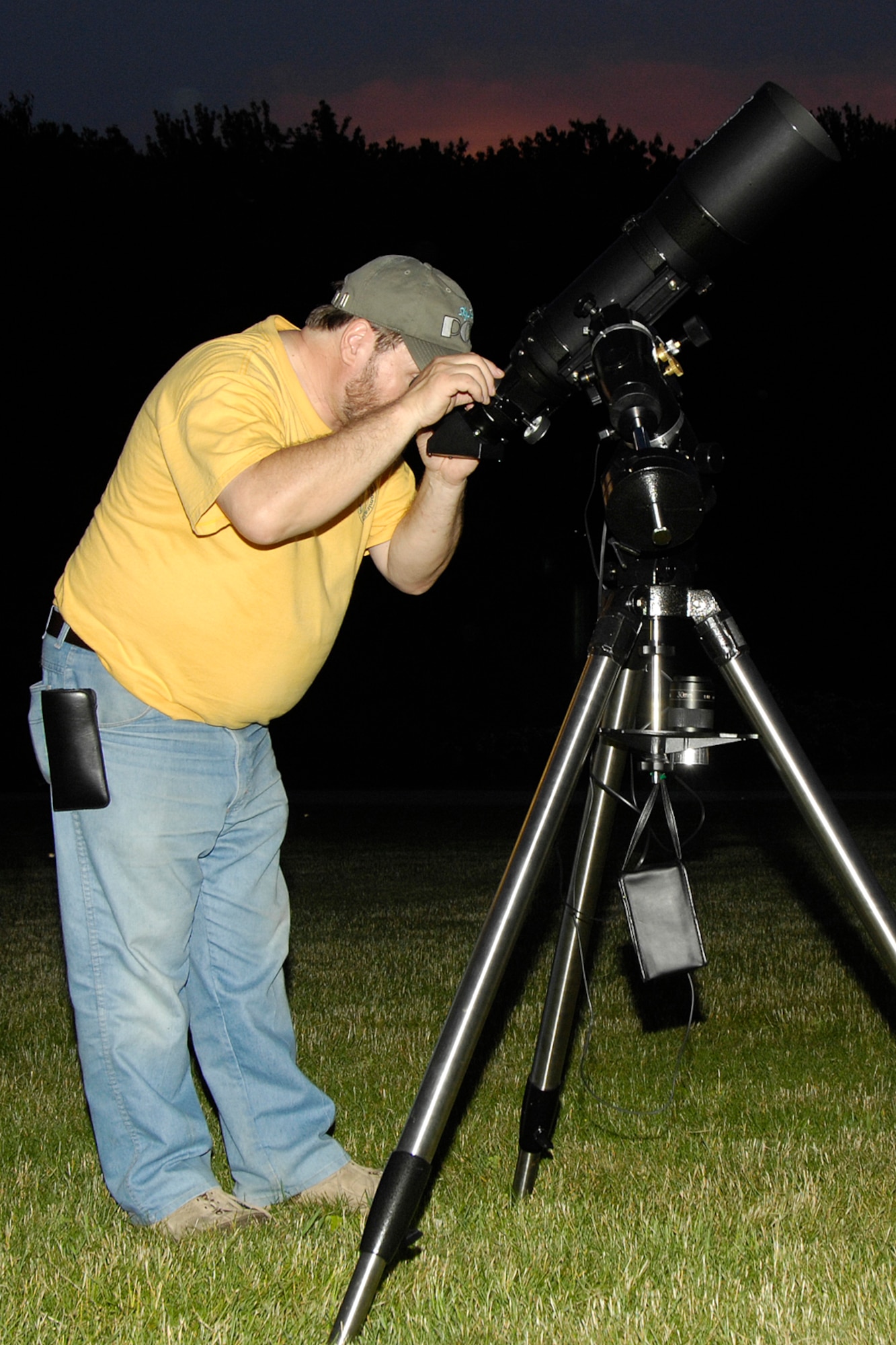 HANSCOM AFB, Mass. -- John Maher, member of the Boston Amateur Telescope Makers club, takes a look through a telescope during Astronomy Night June 7. The event, which began at the Youth Center, helped participants learn about the universe by holding and examining real meteorites and looking through telescopes to see craters on the moon, Saturn’s rings, distant star clusters and galaxies and quasars. (U.S. Air Force photo by Linda LaBonte Britt)