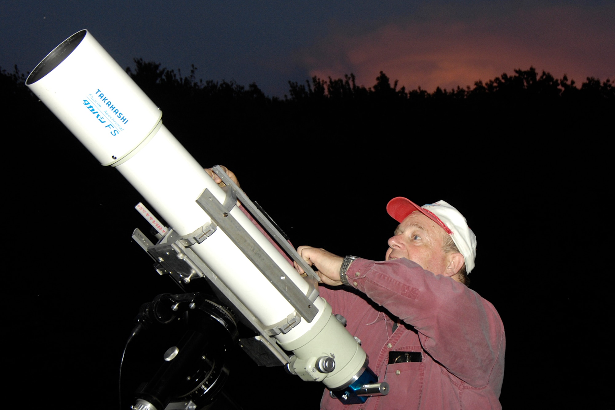 HANSCOM AFB, Mass. -- John Blomquist, member of the Boston Amateur Telescope Makers club, uses a telescope during Astronomy Night June 7. The event, which began at the Youth Center, helped participants learn about the universe by holding and examining real meteorites and looking through telescopes to see craters on the moon, Saturn’s rings, distant star clusters and galaxies and quasars. (U.S. Air Force photo by Linda LaBonte Britt)