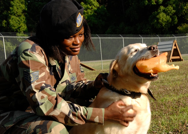 Staff Sgt. Catharine Johnson scratches Liz's back at the K-9 unit training facility on Charleston AFB June 6. Sergeant Johnson is a military working dog handler with the 437th Security Forces Squadron. Liz is a military working dog trained to locate explosive material. (U.S. Air Force photo/Airman 1st Class Katie Gieratz)