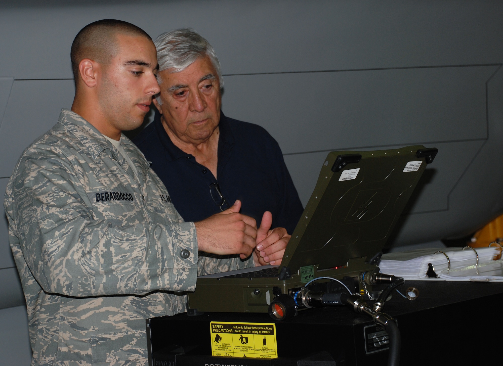 Airman Anthony Barardocco, a student from the 363rd Training Squadron, shows Lt. Gen. Leo Marquez, the former deputy chief of staff for logistics and engineering, some of his F-22 Raptor armament training. (U.S. Air Force photo/Airman 1st Class Jacob Corbin)