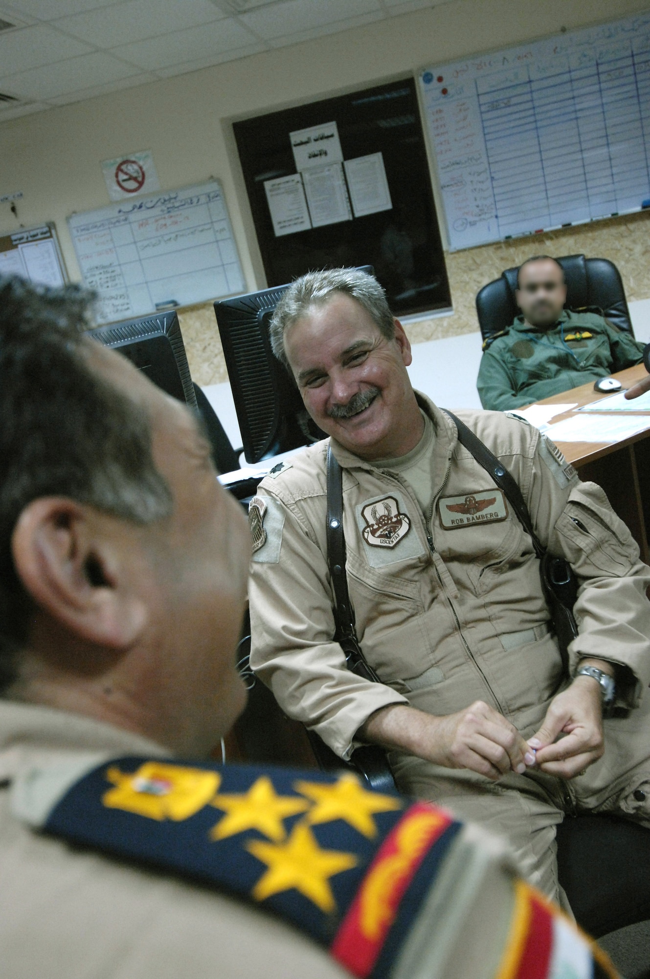 U.S. Air Force Lt. Col Rob Bamberg advises the Iraqi Air Operations Center Gen. about operations center leadership at the Iraqi Air Operations Center at Camp Victory, Iraq on May 28, 2008. Lt. Col Bamberg is a Military Transition Team member advising Iraqi officers concerning the day to day operations in their Air Operations Center. The Iraqi AOC is run completely by Iraqi military officers and advised by U.S. Air Force Military Transition Team (MTT) officers. The AOC MTT is responsible for teaching and preparing the Iraqi military to take over AOC operations independent from the U.S. military.  (U.S. Air Force photo by: Staff Sgt. Christina M. Styer) 

