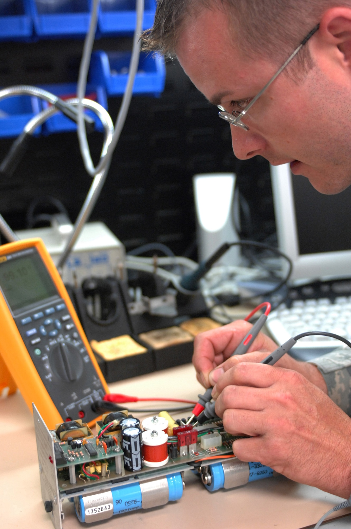 LANGLEY AIR FORCE BASE, Va. -- Tech. Sgt. Eric Bennett troubleshoots a power supply at the Air Force Repair Enhancement Program shop June 3. “If it's broke, we can fix it,” is the motto of AFREP, a general purpose repair shop that works on aircraft parts and miscellaneous devices. Sergeant Bennett, 1st Maintenance Group, is the assistant AFREP manager. (U.S. Air Force photo/Senior Airman Barry Loo)