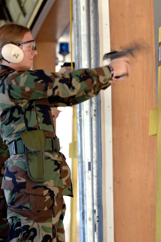 Air Force Reserve Officers' Training Corps Cadet Kathy Rode fires an M9 during a weapons familiarization course at the Combat Arms Training and Maintenance facility here June 6. Rode is one of 13 cadets attending the three-week professional development trip that exposes cadets to real-world Air Force operations. (U.S. Air Force photo/Airman Matthew Flynn)