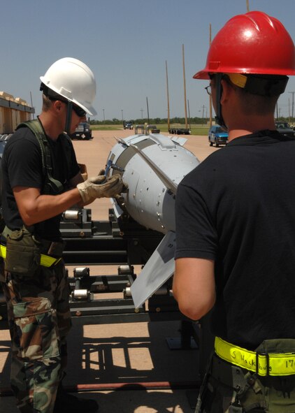 DYESS AIR FORCE BASE, Texas -- Two Airmen from the 7th Munitions Squadron, work together to remove the fin of a bomb June 4. Bombs that are not being used are brought back to the 7th MUNS. (U.S. Air Force photo by Airman 1st Class Jennifer Romig)