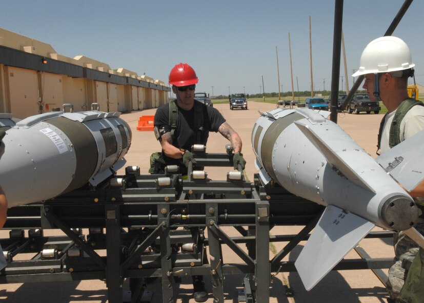 DYESS AIR FORCE BASE, Texas -- A team from the 7th Munitions Squadron, work together to disassemble bombs from a B-1 Lancer June 4. (U.S. Air Force photo by Airman 1st Class Jennifer Romig)