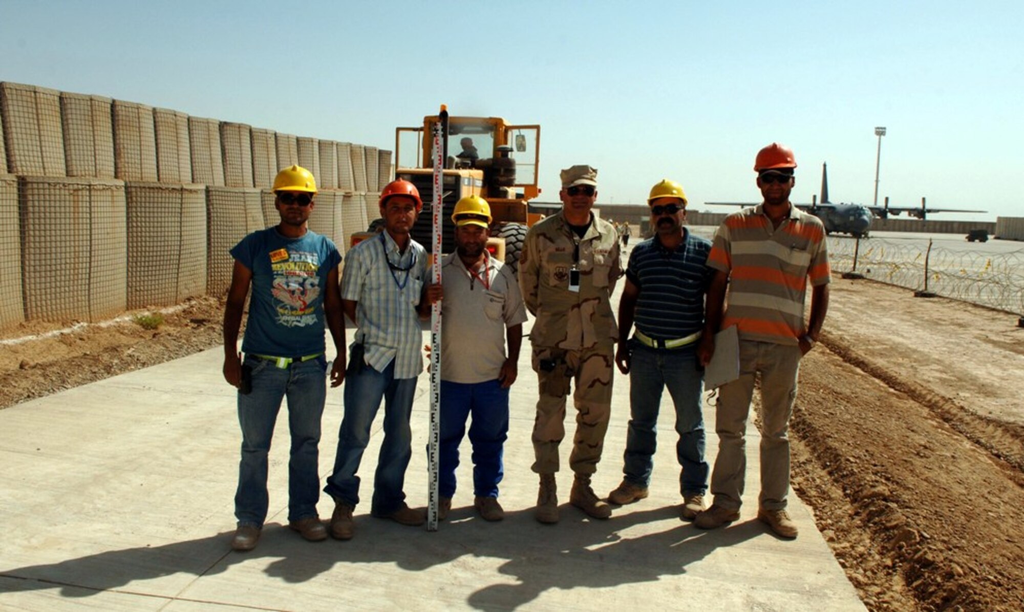 Master Sgt. Chris Selle, 332nd Air Expeditionary Wing superintendent in charge of force protection, stands with third-country nationals at Balad AB, Iraq. Sergeant Selle is an engine propulsion craftsman from the 315th Aircraft Maintenance Squadron who volunteered for this duty, which he extended twice making it a year long.  