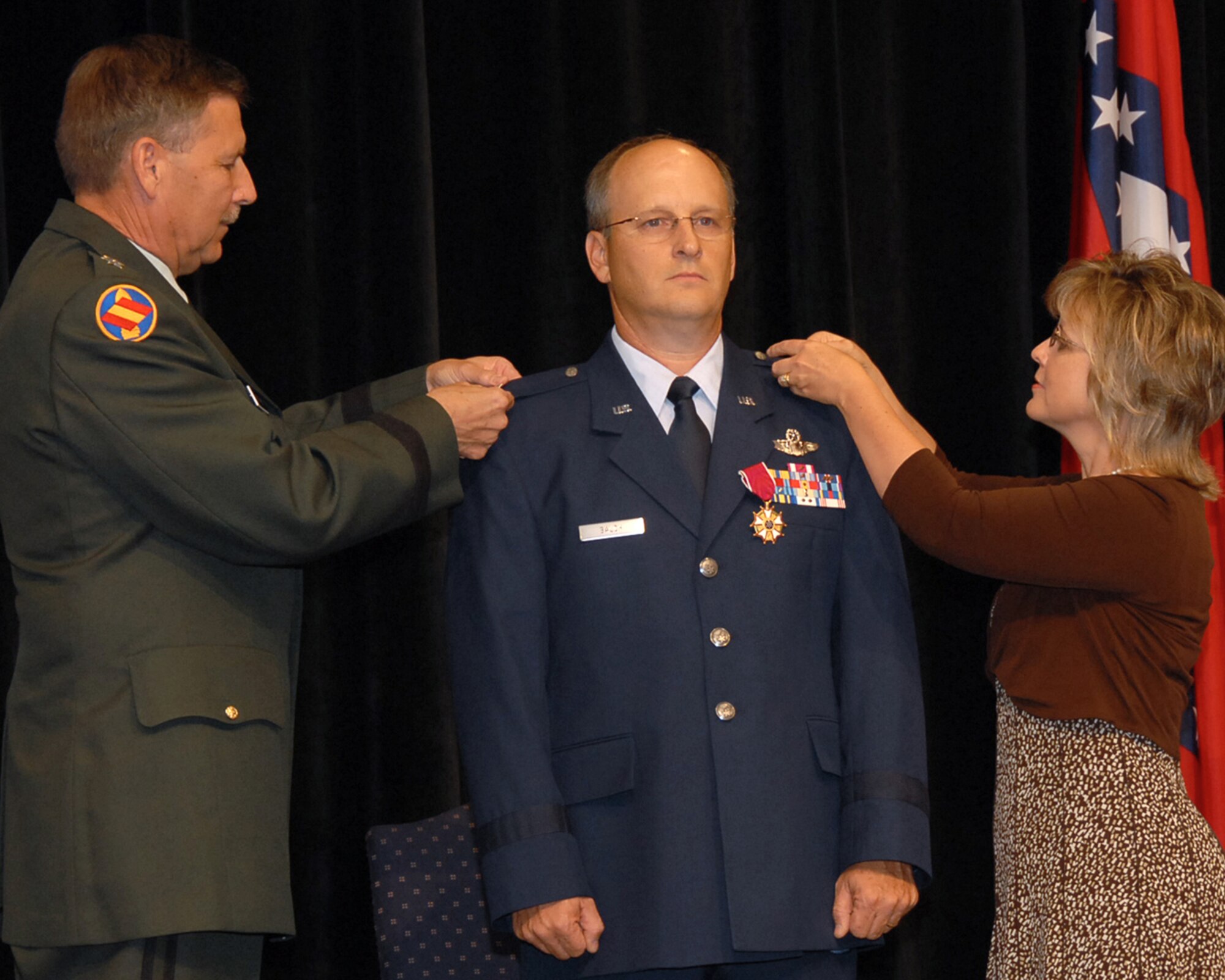 Maj. Gen. William Wofford, Arkansas' adjutant general, and Glo Balch pin brigadier general insignia onto Brig. Gen. Travis D. Balch's uniform at a June 8 ceremony at Camp Joseph T. Robinson in North Little Rock. General Balch is the Arkansas Air National Guard's chief of staff. He is a command pilot with more than 4,500 flying hours in commercial, trainer, tanker and airlift aircraft. (Photo by Master Sgt. Dianna Seerey)