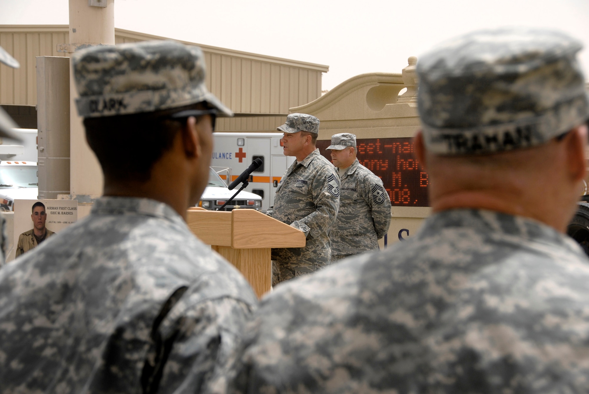 Chief Master Sgt. Richard Bunce speaks during a street dedication ceremony June 10 in Southwest Asia. The ceremony is a tribute to Airman 1st Class Eric Barnes, 20, of Lorain, Ohio, died June 10, 2007, as a result of an improved explosive device attack on an Air Force convoy about 100 miles south of Baghdad, Iraq. He was deployed from the 90th Logistics Readiness Squadron at F.E. Warren Air Force Base, Wyo. Chief Bunce is the 100th Logistics Readiness Squadron chief enlisted manager. (U.S. Air Force photo/Staff Sgt. Patrick Dixon) 
