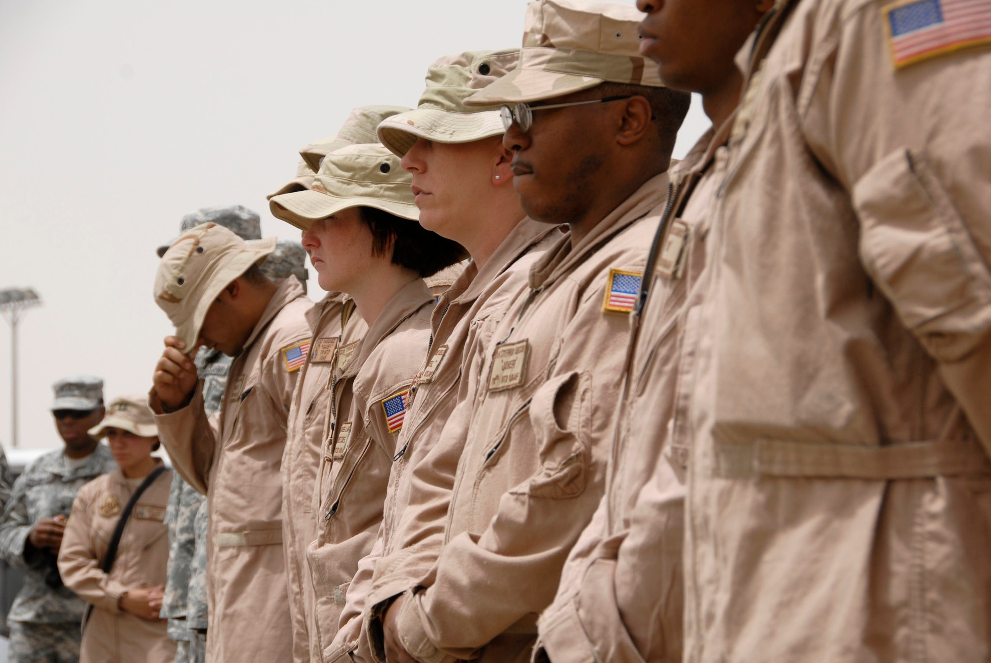 Airmen from the 586th Expeditionary Logistics Readiness Squadron, 70th and 424th Medium Truck detachments, and Soldiers from the Army's 1st Theater Support Command, 640th Sustainment Brigade, 1144th Transportation Battalion, along with other Airmen from the 386th Air Expeditionary Wing, listen to a guest speaker during a street dedication ceremony June 10 in Southwest Asia. The ceremony is a tribute to Airman 1st Class Eric Barnes, 20, of Lorain, Ohio, who died June 10, 2007, as a result of an improved explosive device attack on an Air Force convoy about 100 miles south of Baghdad, Iraq. He was deployed from the 90th Logistics Readiness Squadron at F.E. Warren Air Force Base, Wyo. (U.S. Air Force photo/Staff Sgt. Patrick Dixon) 