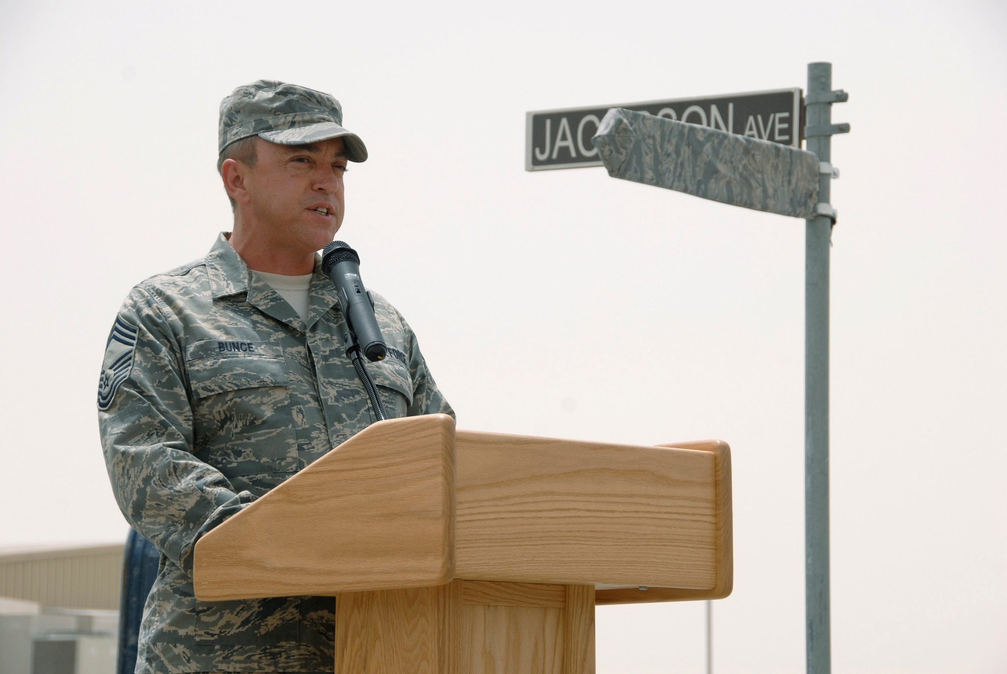 Chief Master Sgt. Richard Bunce speaks during a street dedication ceremony June 10 in Southwest Asia. The ceremony is a tribute to Airman 1st Class Eric Barnes and his family, with the naming of Barnes Road. Airman Barnes, 20, of Lorain, Ohio, died June 10, 2007, as a result of an improved explosive device attack on an Air Force convoy about 100 miles south of Baghdad, Iraq. He was deployed from the 90th Logistics Readiness Squadron at F.E. Warren Air Force Base, Wyo. Chief Bunce is the 100th Logistics Readiness Squadron chief enlisted manager. (U.S. Air Force photo/Staff Sgt. Patrick Dixon) 