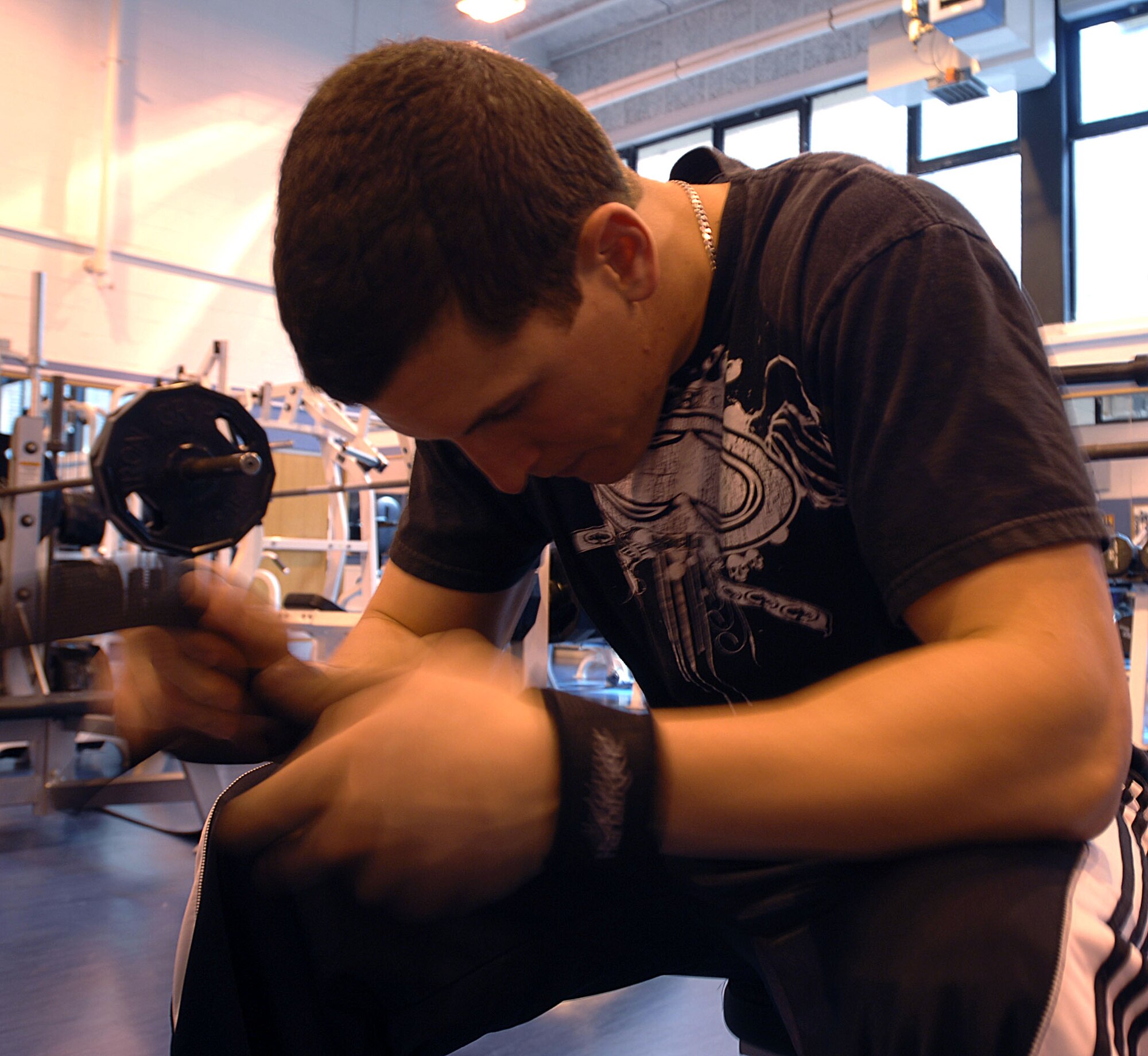 Airman 1st Class Justin Garcia, 100th Services Squadron, mentally prepares himself before attempting the second round in the bench-press portion of a weightlifting competion in the fitness Center at RAF Mildenhall. Airman Garcia also organized the event. (U.S. Air Force photo by Master Sgt. Sarah Frankenhoff)