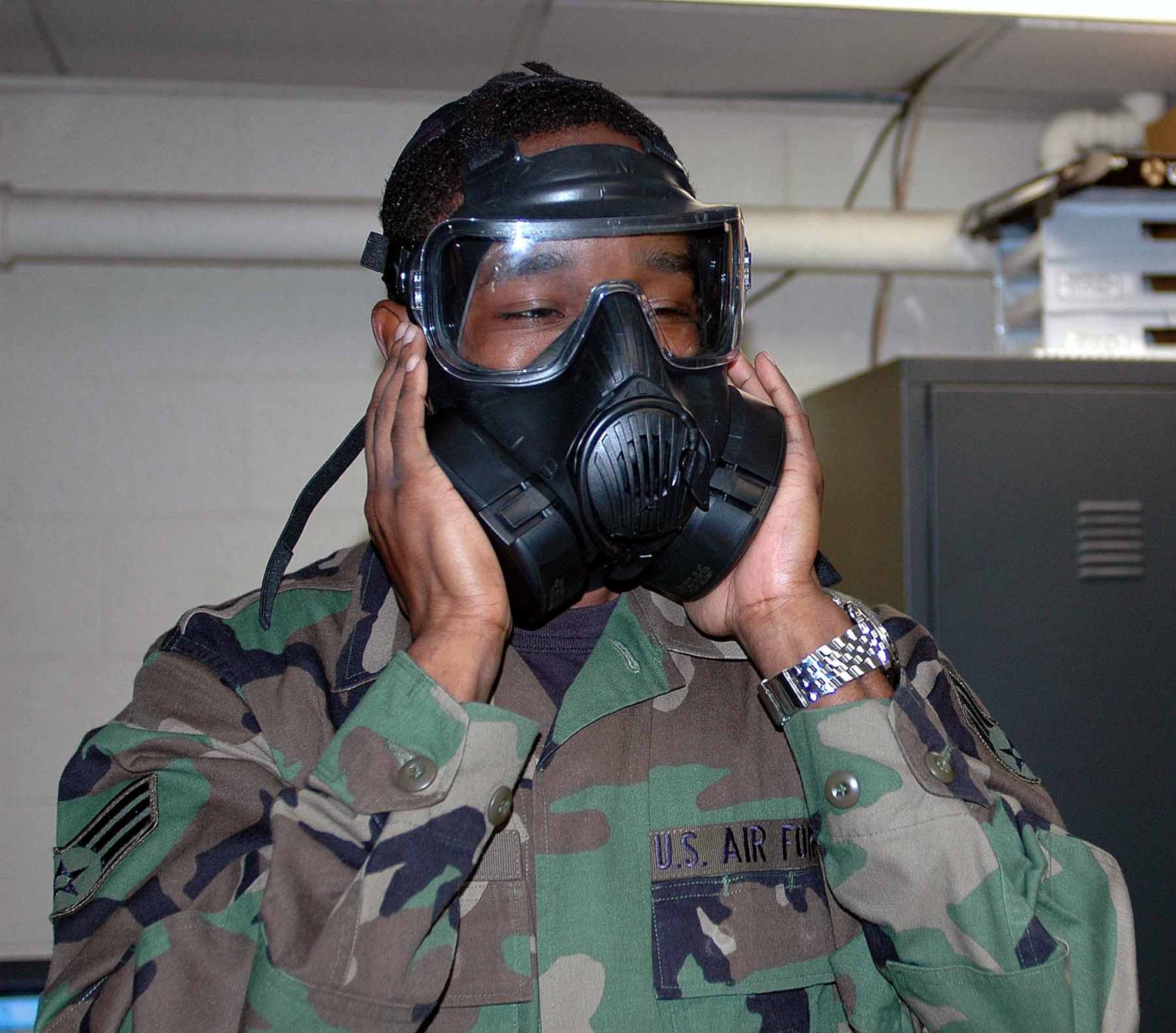 OSAN AIR BASE, Republic of Korea -- Senior Airman Marcus Easterling, 51st Dental Squadron, checks the seal on his new M-50 during a training class June 9. (U.S. Air Force photo/Staff Sgt. Candy Knight)