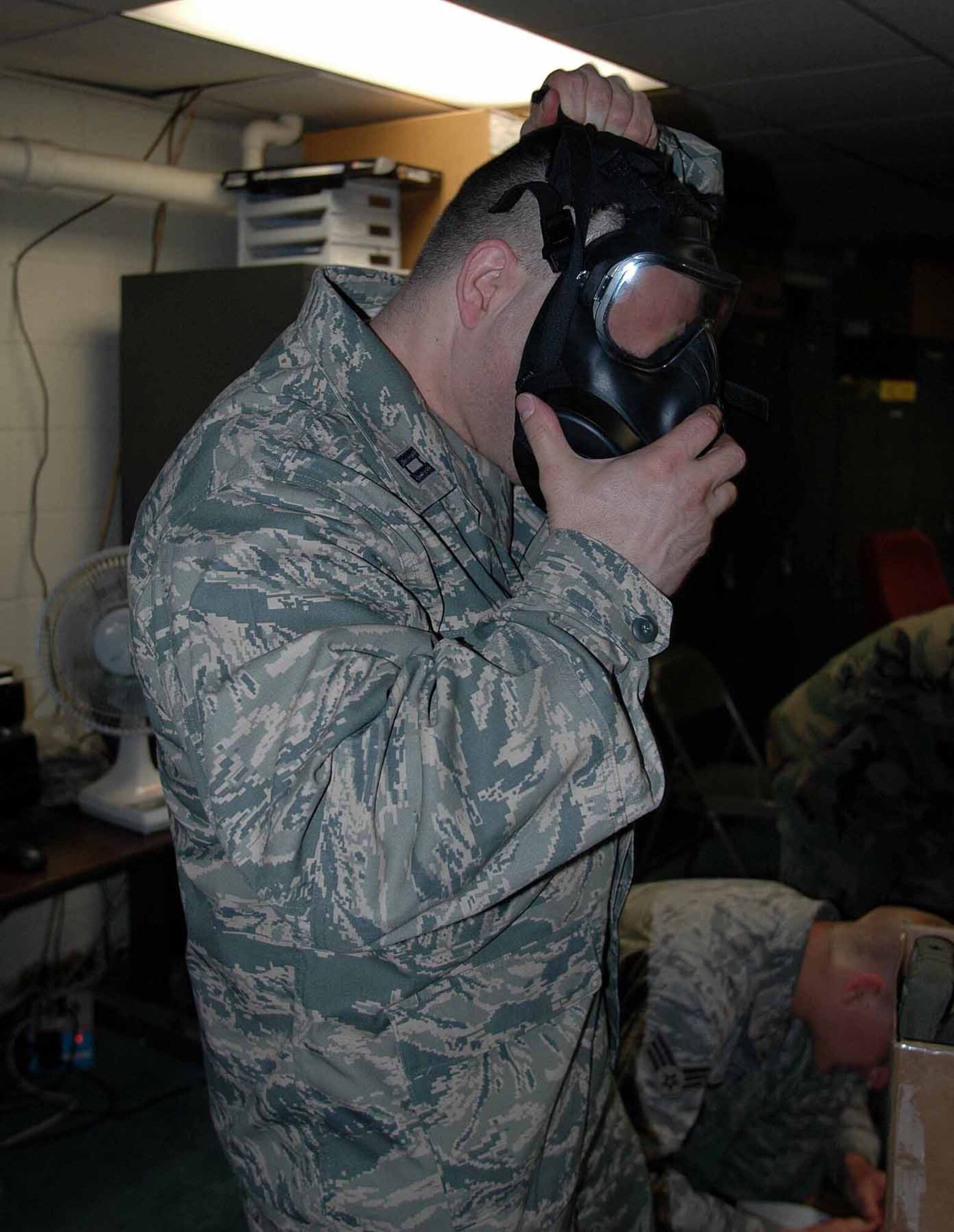 OSAN AIR BASE, Republic of Korea -- Capt. Tod Frazer, 51st Medical Operations Squadron, dons his new M-50 during a training class. Osan Airmen began receiving the new M-50 mask June 9. (U.S. Air Force photo/Staff Sgt. Candy Knight)