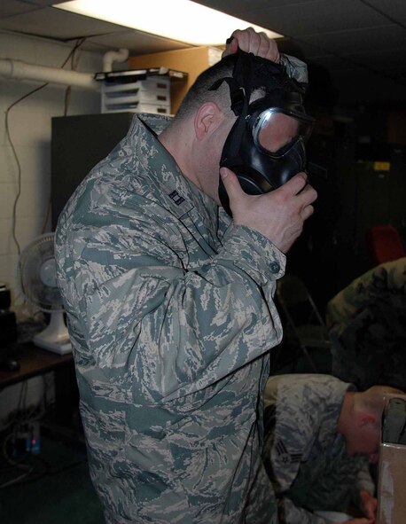 OSAN AIR BASE, Republic of Korea -- Capt. Tod Frazer, 51st Medical Operations Squadron, dons his new M-50 during a training class. Osan Airmen began receiving the new M-50 mask June 9. (U.S. Air Force photo/Staff Sgt. Candy Knight)