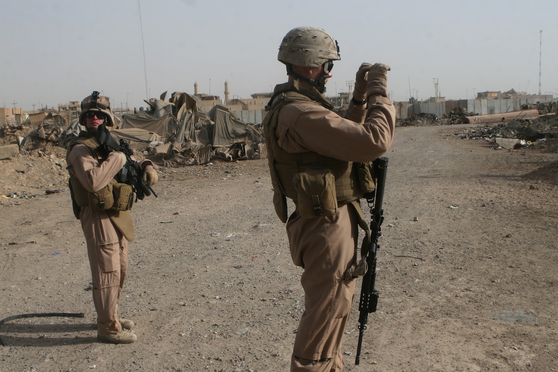 (June 11, 2008) – Sgt. Joseph Gaines, squad leader of Civil Affairs Team 5, photographs a junkyard in the corner of the Fallujah Government Center, June 11. The team assesses projects to improve the local infrastructure to ensure quality work. (Official U.S. Marine Corps photo by Cpl. Chris Lyttle) (RELEASED)