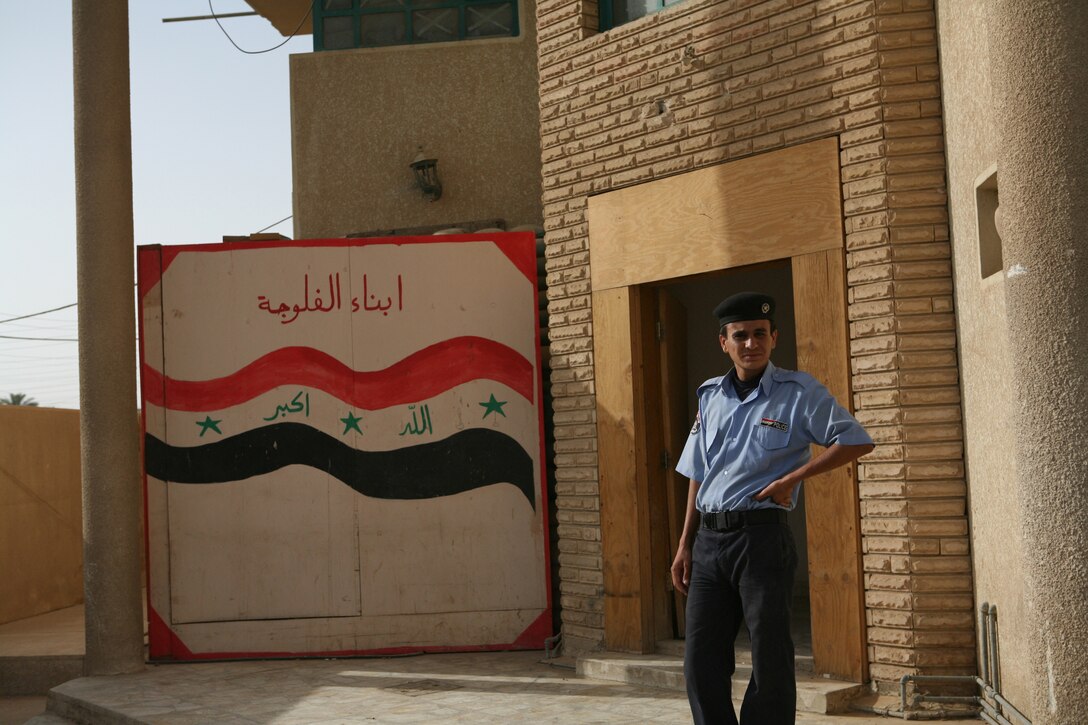 An Iraqi Policeman with the 9th Fallujah Precinct stands watch to check IDs and provide security for the Al Hareth Police Station June 10.
