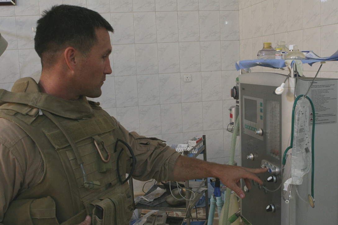 Lt. j.g. Warren Karr, an emergency nurse with the Shock Trauma Platoon, Combat Logistics Battalion 6, attached to Task Force 2nd Bn., 2nd Marines, Regimental Combat Team 5, observes an anesthesia machine at the Husaybah Hospital, June 11. Karr and two colleagues explored the ins and outs of the hospital, speaking to staff along the way. Their mission was to determine the needs of the hospital and develop plans to help meet those needs.