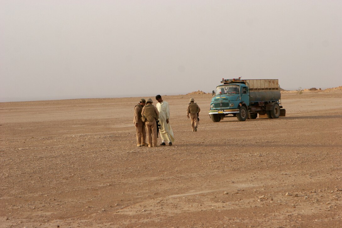 June 11, 2008) - Marines of 2nd platoon, Bravo Company, Marine Wing Support Squadron 274, 3rd Marine Aircraft Wing (Forward), speak to an Iraqi national and search his vehicle for contraband during a mounted security patrol June 11. The Marines search and speak to all local nationals they come across during patrols ensuring they aren't hiding any contraband.