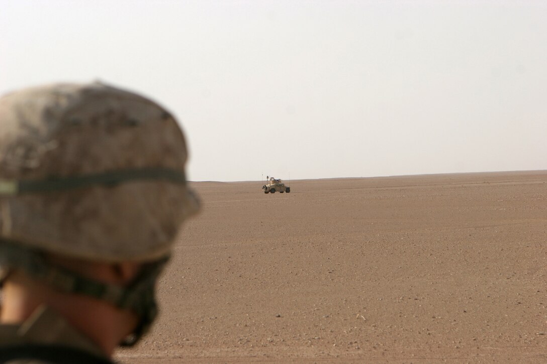 (June 11, 2008) ? Cpl. Jason Bellavance, Humvee driver, 2nd platoon, Bravo Company, Marine Wing Support Squadron 274, 3rd Marine Aircraft Wing (Forward), looks on during a halted period on a mounted security patrol June 11. The Marines of MWSS-274 come from a myriad of different military occupational specialties in the rear but all fill the role as a provisional infantry  battalion conducting security tasks while deployed to Iraq.