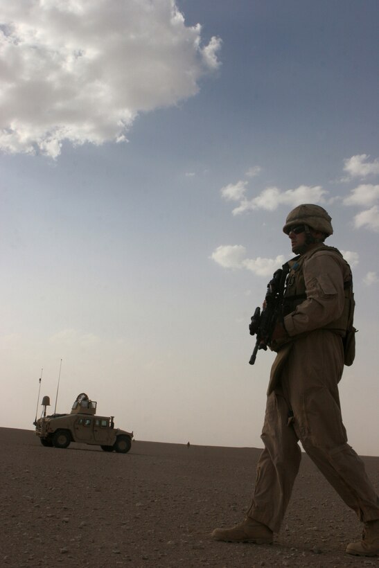 (June 11, 2008) ? Cpl. Jason Bellavance, Humvee driver, 2nd platoon, Bravo Company, Marine Wing Support Squadron 274, 3rd Marine Aircraft Wing (Forward), takes a look around on a foot patrol June 11. The Marines look for anything unusual, from hostile threats to Iraqi civilians traveling through the desert.