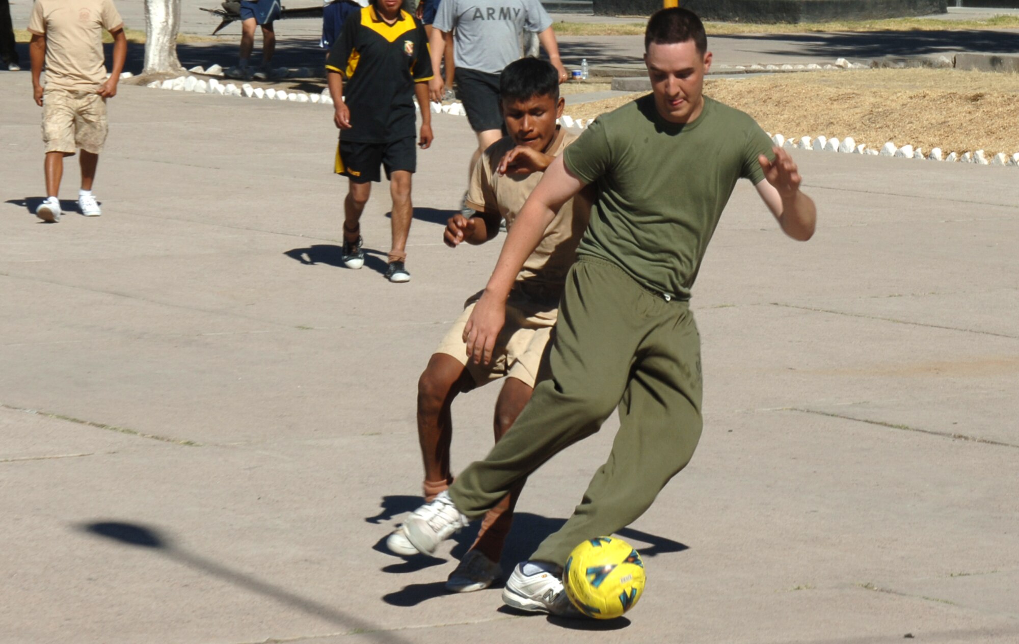 U.S. Marine Lance Cpl. Matthew Carroll, assigned to Task Force New Horizons, dribbles a ball around a Peruvian soldier, June 8 , in a soccer game between the U.S. and Peruvian militaries during New Horizons Peru 2008, a U.S. and Peruvian effort to bring relief to underprivileged Peruvians.  (U.S. Air Force photo/Tech. Sgt. Kerry Jackson)