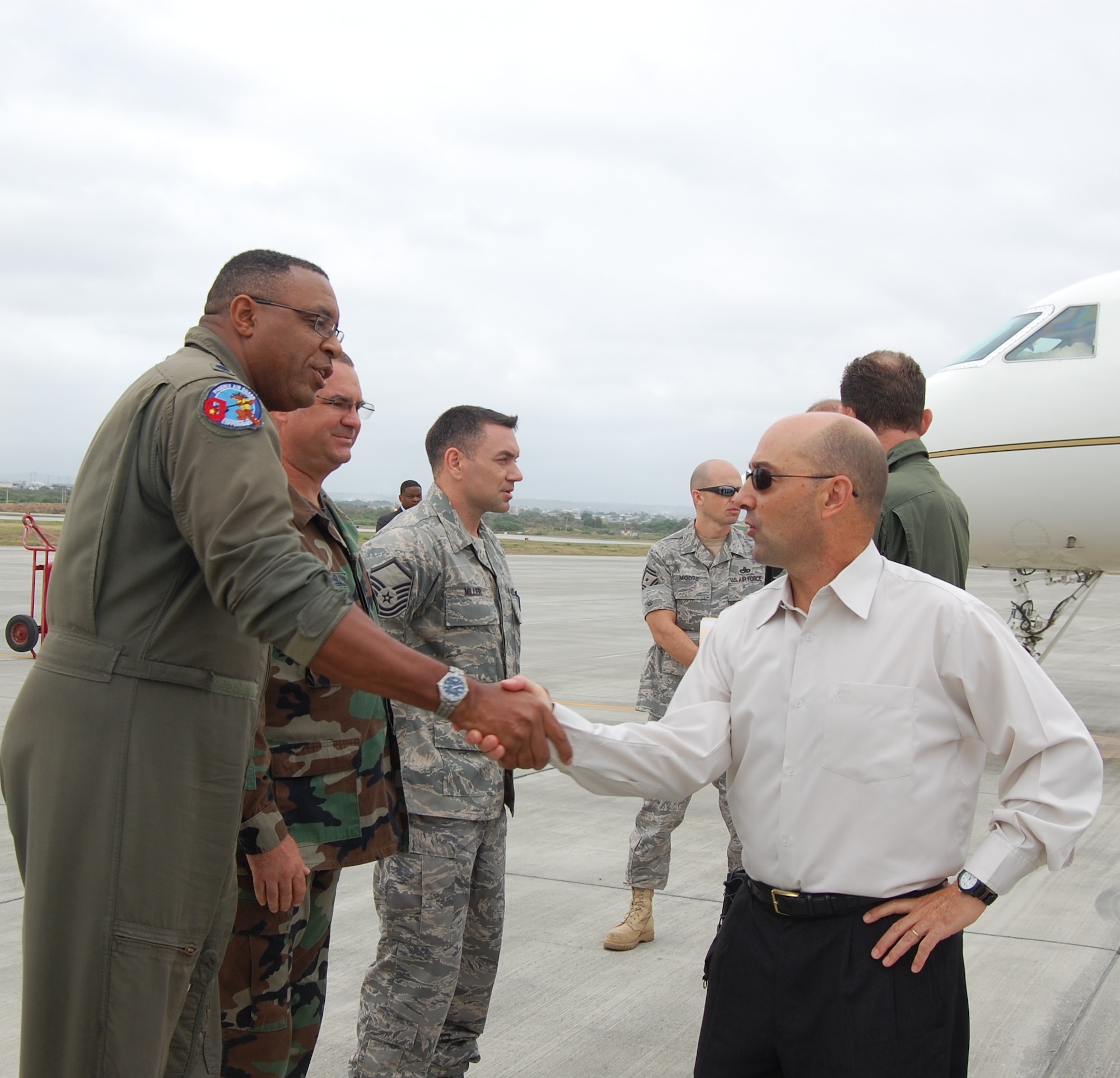 Admiral James Stavridis, U.S. Southern Command commander, greets Lieutenant Colonel Khrisna Greene, a pilot with the 61st Air Refueling Wing deployed to Forward Operating Location Manta, Ecuador.  Admiral Stavridis spent several hours visiting with Airmen and getting a tour of the FOL on June 12.  Lt. Col. Greene was coined by the Admiral for being a top performer.  (U.S. Air Force photo/Capt. Ashley Norris)