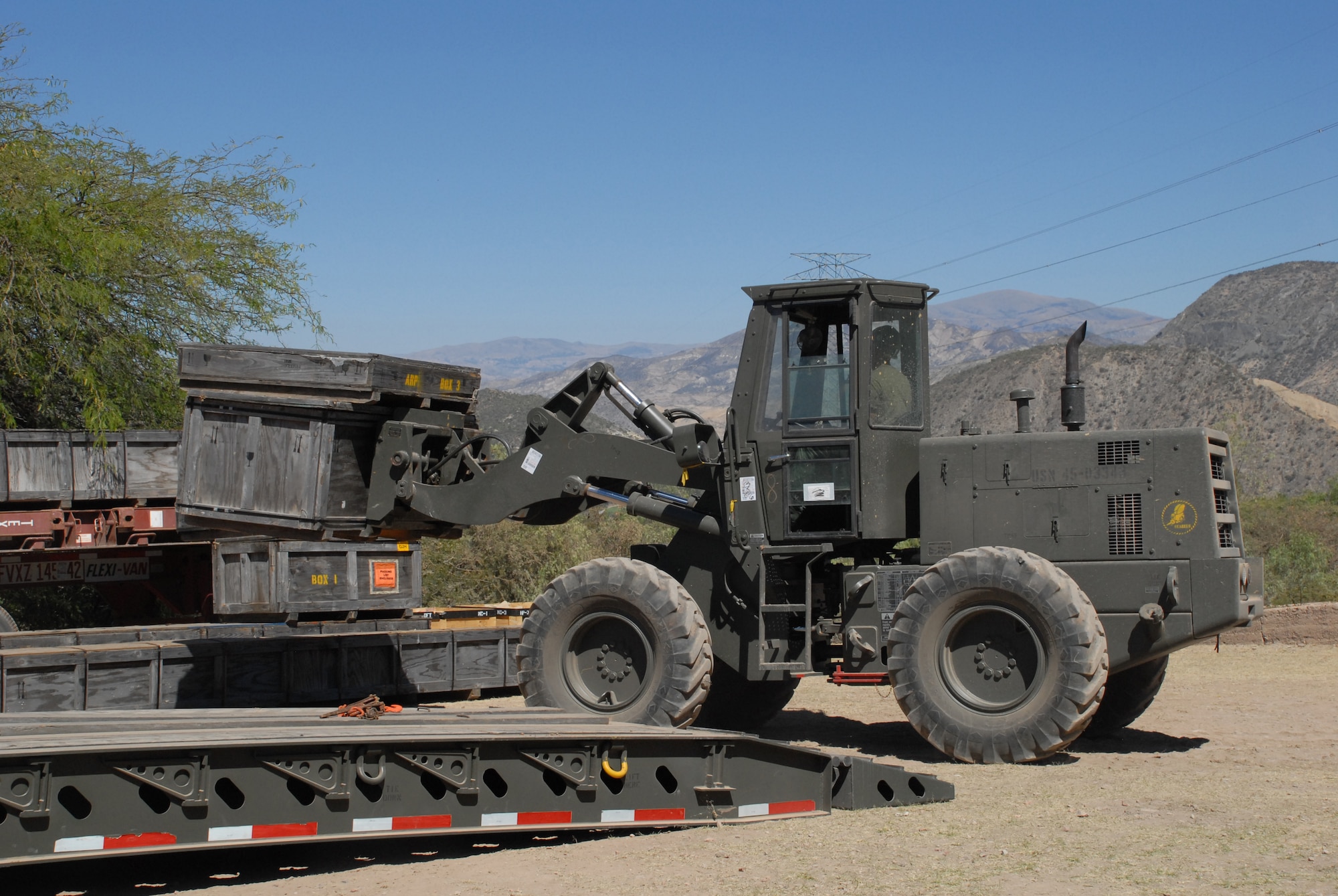 U.S. Navy servicemembers, deployed from Golf Port, Miss., unload equipment at the construction site in Huanta, Peru, where wells are being built in support of New Horizons Peru 2008, a humanitarian event that benefits underprivileged Peruvians. U.S. Air Force, Army, Marines, and Navy servicemembers came together to build new schools, clinics, and water wells which will accommodate nearly 5,200 Peruvians. (U.S. Air Force photo/Airman 1st Class Tracie Forte)