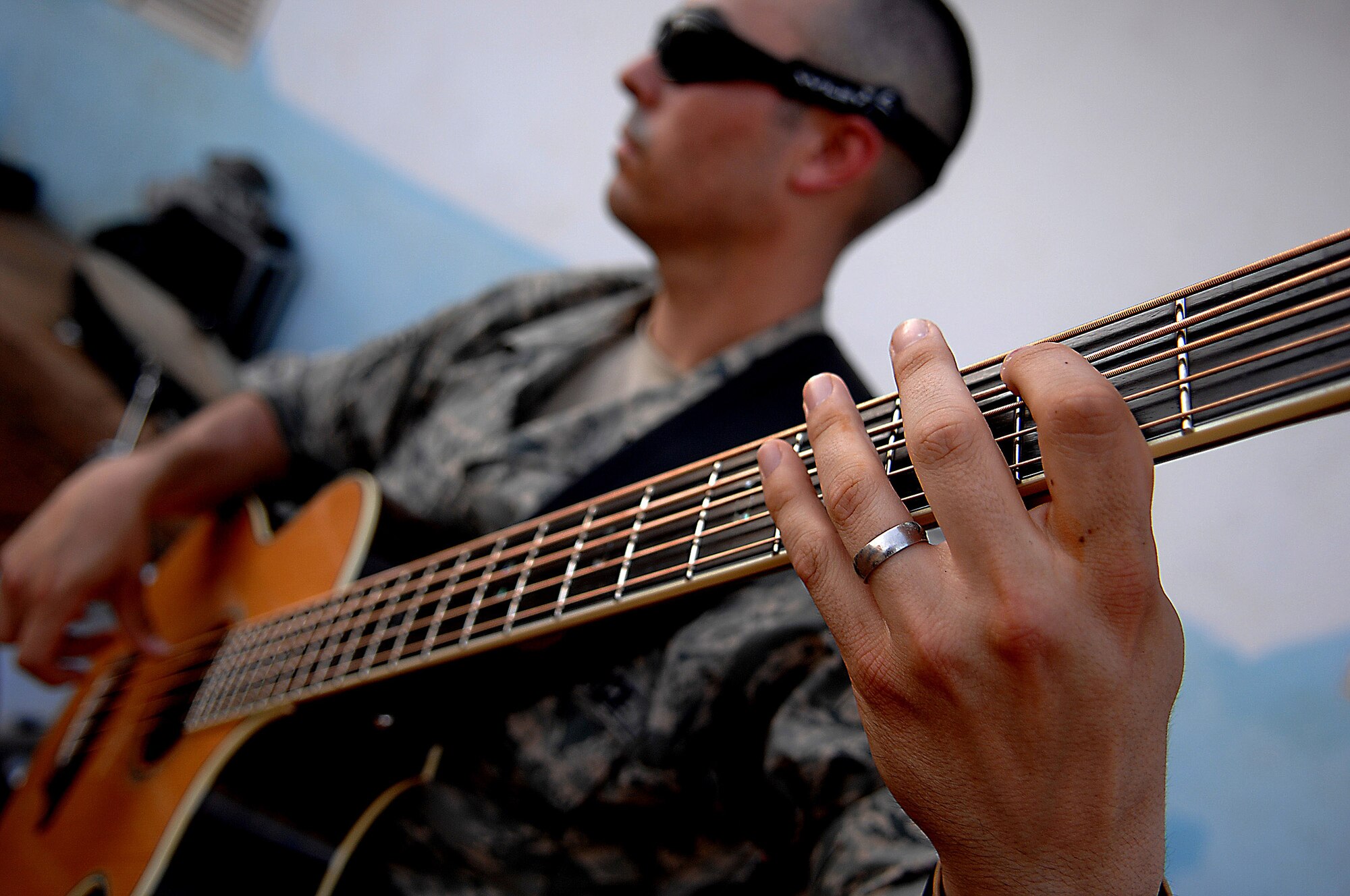 Senior Airman John D. Beasley performs for villagers May 22 in Negad, Djibouti.  The band is deployed to support Combined Joint Task Force - Horn of Africa out of Camp Lemonier, Djibouti.  Airman Beasley is the bass player with the Air Force Central Command band, Falcon.  (U.S. Air Force photo/Tech. Sgt. Jeremy T. Lock)