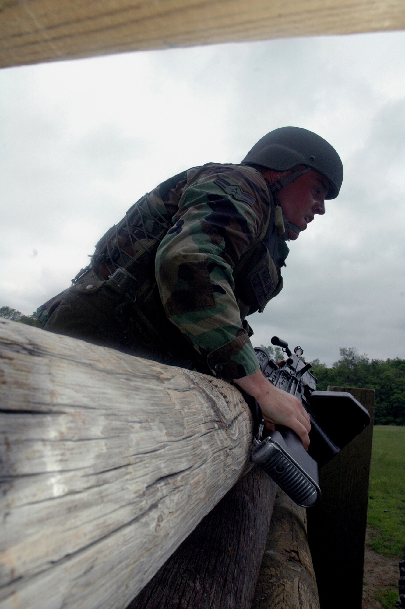 A student in the Air Force Phoenix Warrior Training Course 08-5 climbs over an obstacle during training in a combat first aid class on a Fort Dix, N.J., range June 5, 2008.  The course is taught by the U.S. Air Force Expeditionary Center's Expeditionary Operations School and 421st Combat Training Squadron and prepares security forces Airmen for upcoming deployments. Annually, the USAF EC trains more than 23,000 students in expeditionary- and mobility air force-based courses both with in-residence and distance learning.  (U.S. Air Force Photo/Tech. Sgt. Scott T. Sturkol)
