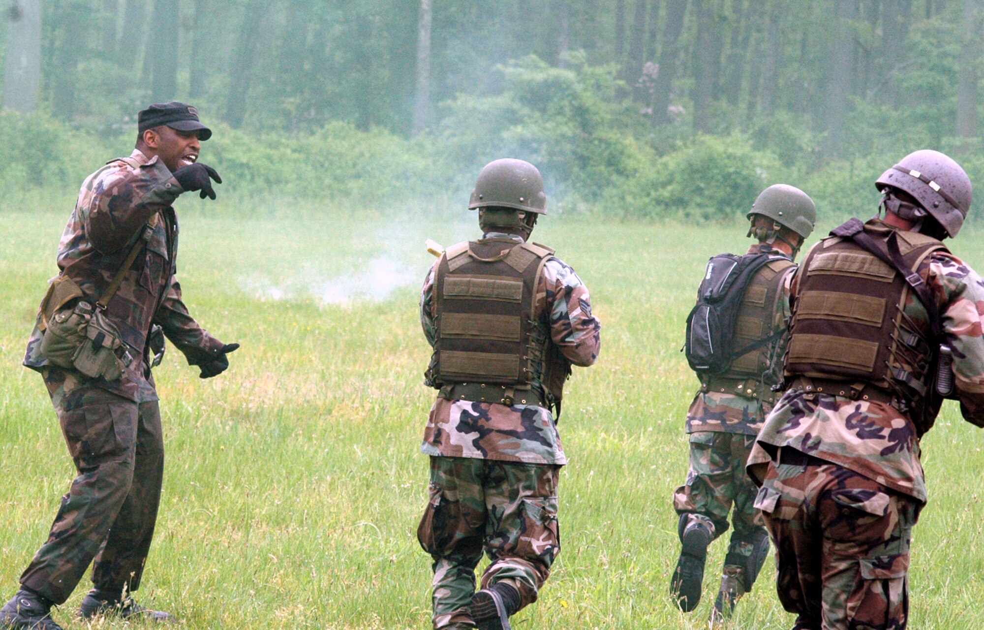 Instructor Tech. Sgt. Rudolph Stuart urges students in the Air Force Phoenix Warrior Training Course 08-5 forward during training in a combat first aid class on a Fort Dix, N.J., range June 5, 2008.  The course is taught by the U.S. Air Force Expeditionary Center's Expeditionary Operations School and 421st Combat Training Squadron and prepares security forces Airmen for upcoming deployments. Annually, the USAF EC trains more than 23,000 students in expeditionary- and mobility air force-based courses both with in-residence and distance learning.  (U.S. Air Force Photo/Tech. Sgt. Scott T. Sturkol)