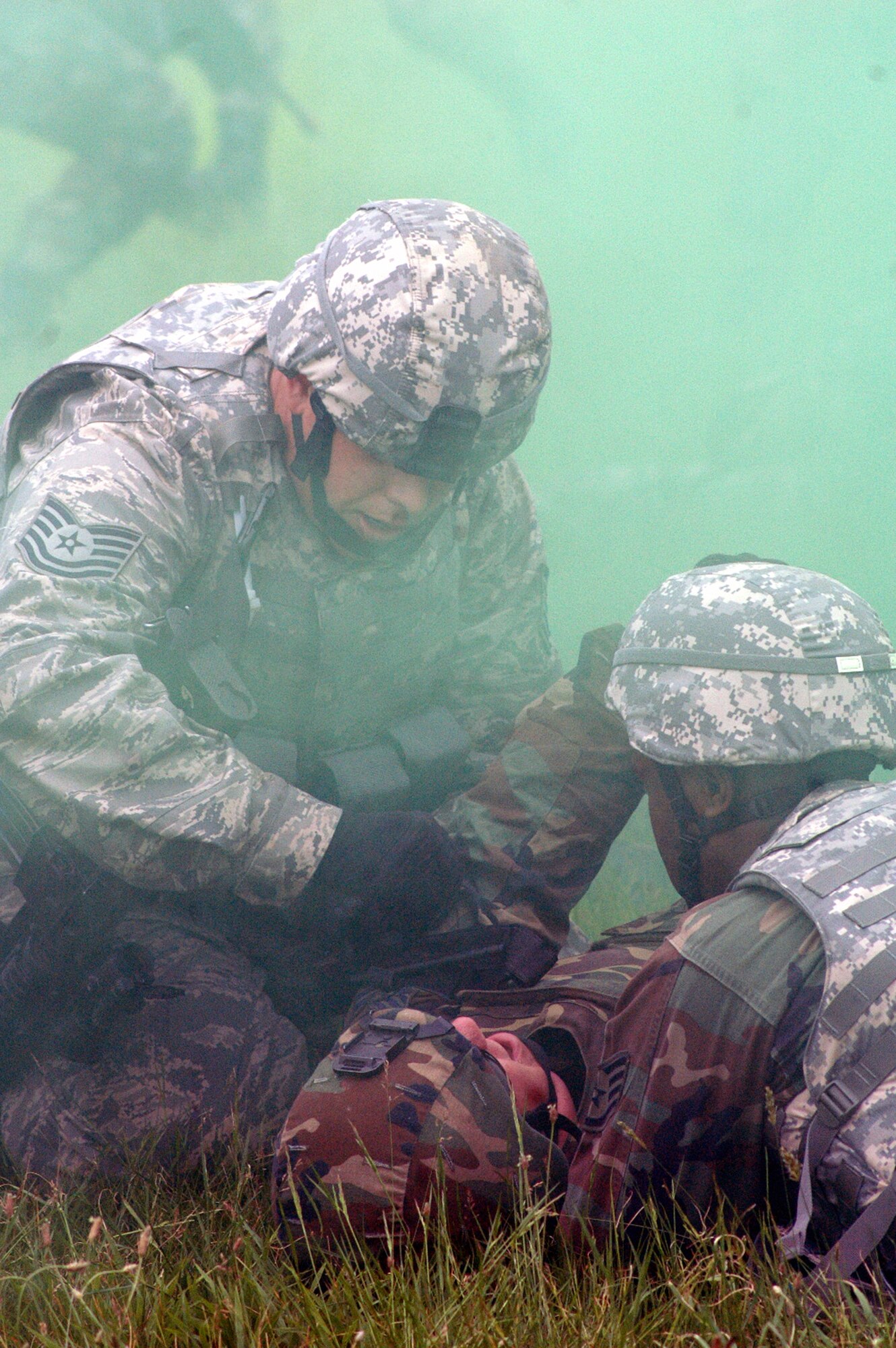 Students in the Air Force Phoenix Warrior Training Course 08-5 tend to a "victim" during training in a combat first aid class on a Fort Dix, N.J., range June 5, 2008.  The course is taught by the U.S. Air Force Expeditionary Center's Expeditionary Operations School and 421st Combat Training Squadron and prepares security forces Airmen for upcoming deployments. Annually, the USAF EC trains more than 23,000 students in expeditionary- and mobility air force-based courses both with in-residence and distance learning.  (U.S. Air Force Photo/Tech. Sgt. Scott T. Sturkol)