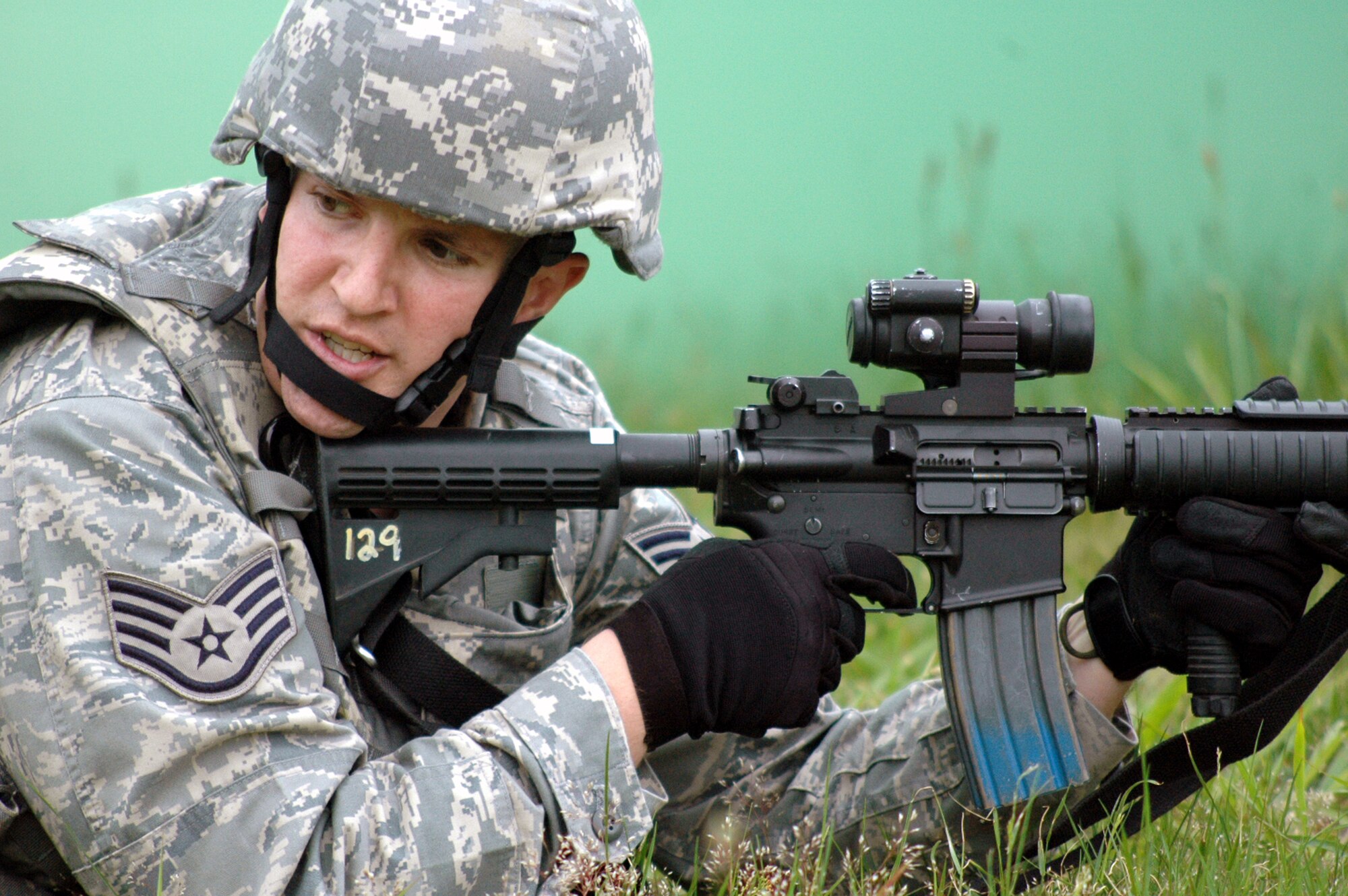 A student in the Air Force Phoenix Warrior Training Course 08-5 provides security during training in a combat first aid class on a Fort Dix, N.J., range June 5, 2008.  The course is taught by the U.S. Air Force Expeditionary Center's Expeditionary Operations School and 421st Combat Training Squadron and prepares security forces Airmen for upcoming deployments. Annually, the USAF EC trains more than 23,000 students in expeditionary- and mobility air force-based courses both with in-residence and distance learning.  (U.S. Air Force Photo/Tech. Sgt. Scott T. Sturkol)