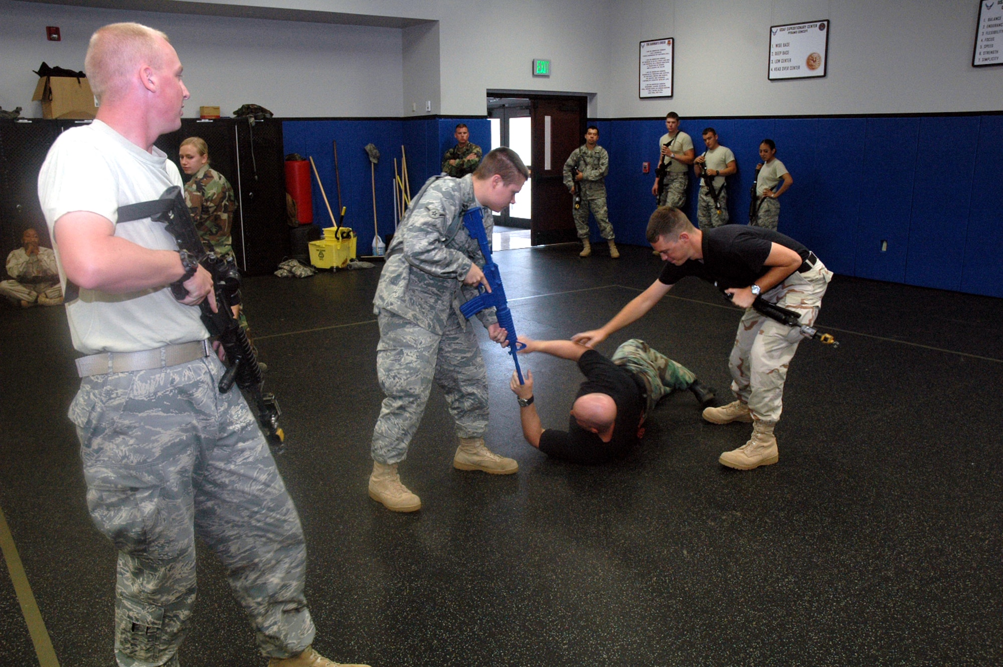 Students in the Air Force Phoenix Warrior Training Course 08-5 practice proper technique for military operations in urban terrain during a "tape drills" class in the U.S. Air Force Expeditionary Center on Fort Dix, N.J., June 5, 2008.  The course is taught by the USAF EC's Expeditionary Operations School and 421st Combat Training Squadron and prepares security forces Airmen for upcoming deployments. Annually, the USAF EC trains more than 23,000 students in expeditionary- and mobility air force-based courses both with in-residence and distance learning.  (U.S. Air Force Photo/Tech. Sgt. Scott T. Sturkol)