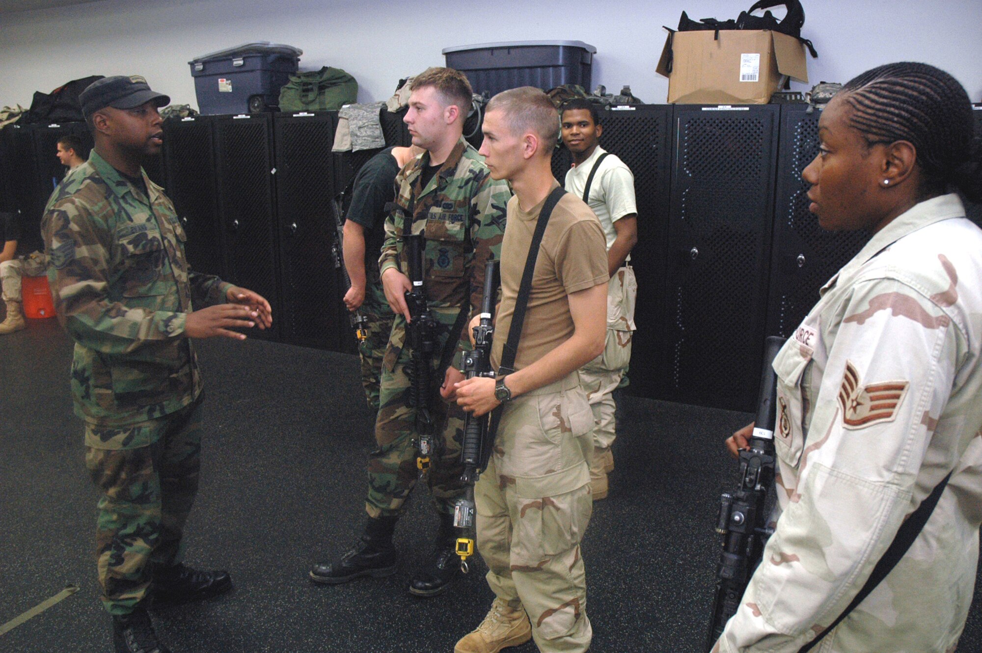 Instructor Staff Sgt. Cecil Evans shows students in the Air Force Phoenix Warrior Training Course 08-5 proper technique for military operations in urban terrain during a "tape drills" class in the U.S. Air Force Expeditionary Center on Fort Dix, N.J., June 5, 2008.  The course is taught by the USAF EC's Expeditionary Operations School and 421st Combat Training Squadron and prepares security forces Airmen for upcoming deployments. Annually, the USAF EC trains more than 23,000 students in expeditionary- and mobility air force-based courses both with in-residence and distance learning.  (U.S. Air Force Photo/Tech. Sgt. Scott T. Sturkol)