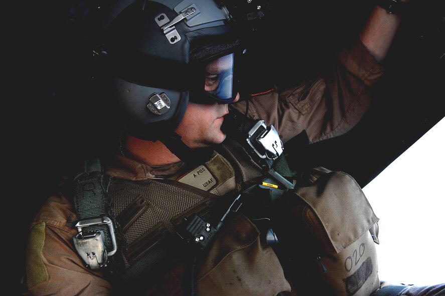 Tech. Sgt. James Floyd watches a smoke grenade June 3 from the back ramp an HC-130 Hercules during a mission off the coast of Djibouti. Sergeant Floyd is deployed to Combined Joint Task Force-Horn of Africa out of Camp Lemonier, Djibouti. The loadmaster is from the 71st Search and Rescue Squadron at Moody Air Force Base, Ga. (U.S. Air Force photo/Tech. Sgt. Jeremy T. Lock)
