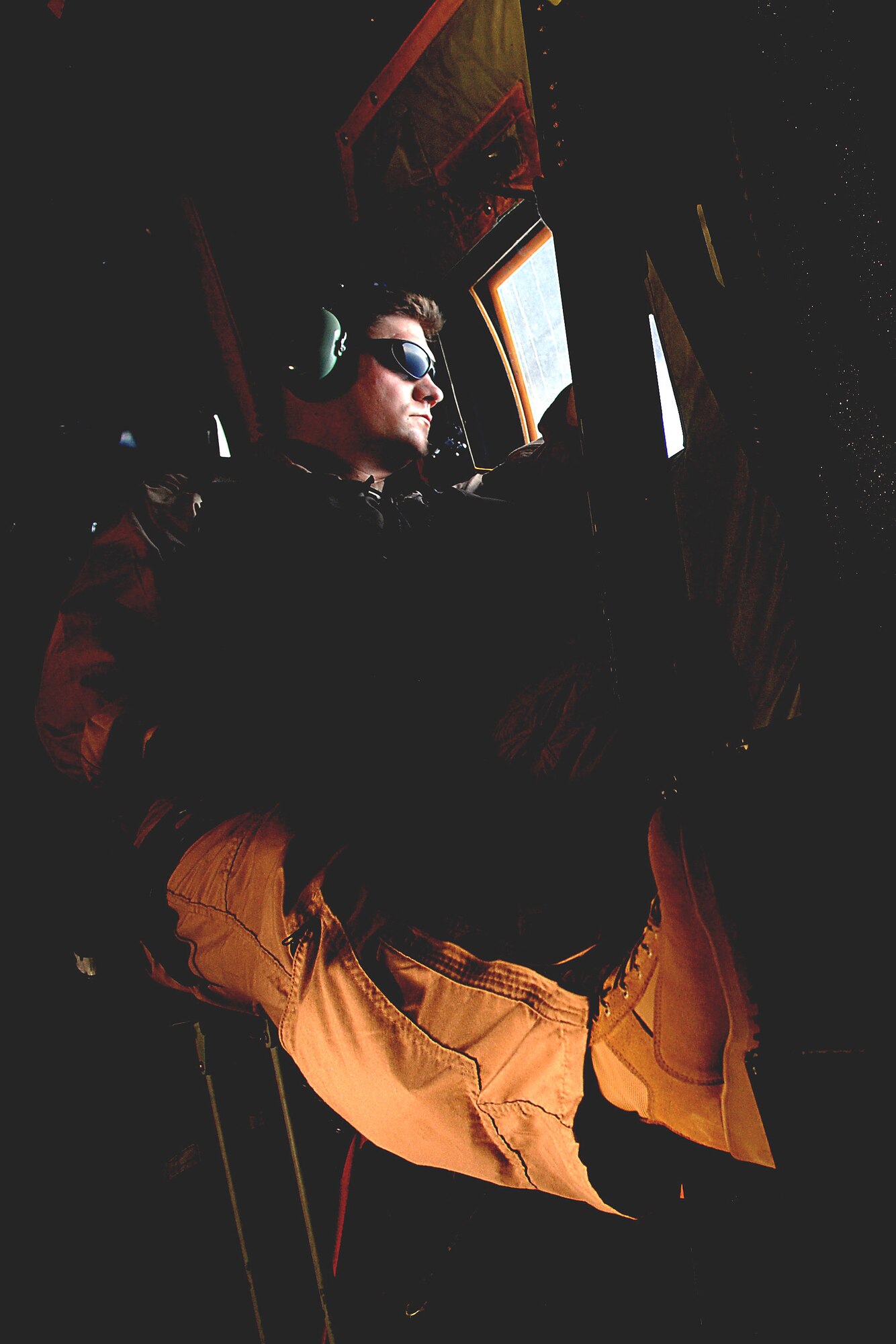 Tech. Sgt. James Floyd scans the sky from the jump door window of an HC-130 Hercules during a mission June 3 off the coast of Djibouti. Sergeant Floyd is deployed to Combined Joint Task Force-Horn of Africa out of Camp Lemonier, Djibouti. The aircraft loadmaster is with the 71st Search and Rescue Squadron at Moody Air Force Base, Ga. (U.S. Air Force photo/Tech. Sgt. Jeremy T. Lock) 