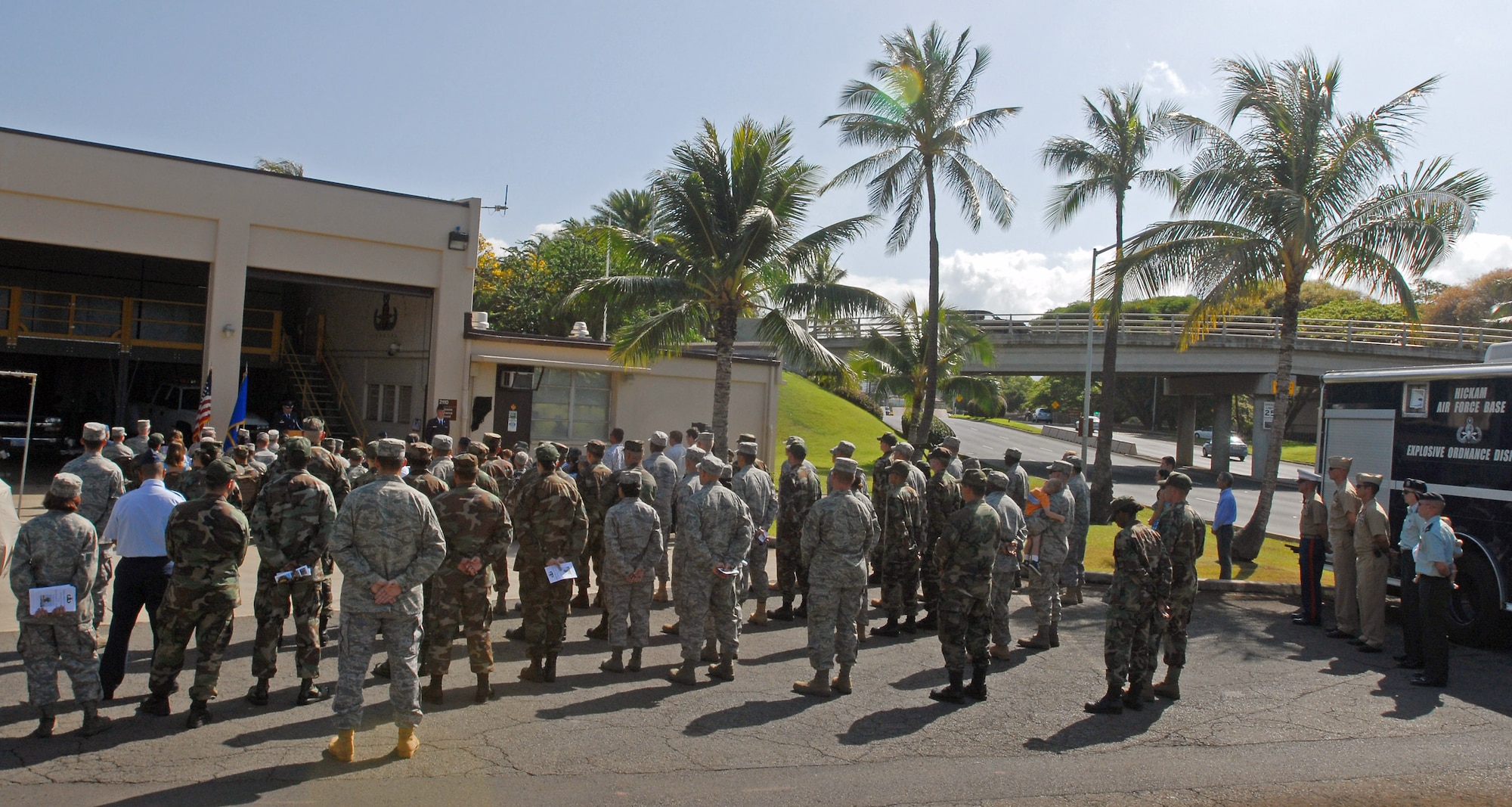 Family, friends and fellow servicemembers pay respect during a dedication ceremony in memory of Senior Airman William Newman June 7 at the 15th Civil Engineer Squadron Explosive Ordnance facility at Hickam Air Force Base, Hawaii. The tribute was in honor of Airmen Newman for giving his life to protect the people of Iraq and the lives of the Soldiers and Airmen operating with him on his last mission June 7, 2007. (U.S. Air Force photo)