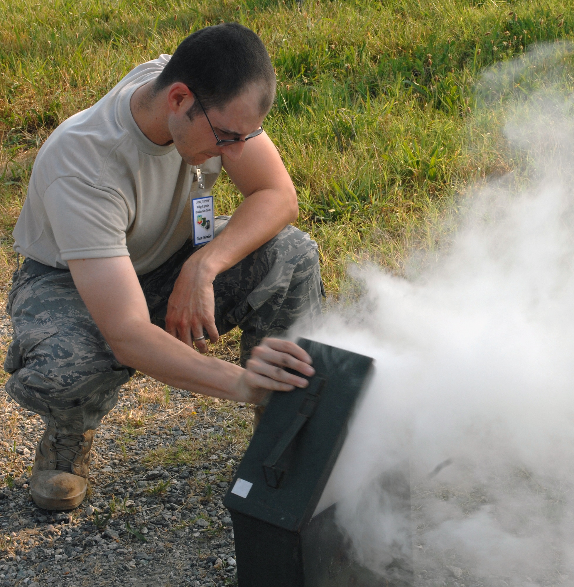 LANGLEY AIR FORCE BASE, Va. -- Tech. Sgt. Richard Stein, 1st Maintenance Group, Air Force Repair Enhancement Program technician, provides smoke for a simulated fire during a major accident response exercise here, June 11.  The MARE was conducted to train base personnel on emergency response procedures and to establish working agreements with local civilian agencies.  (U.S. Air Force photo/Airman 1st Class Zachary Wolf)