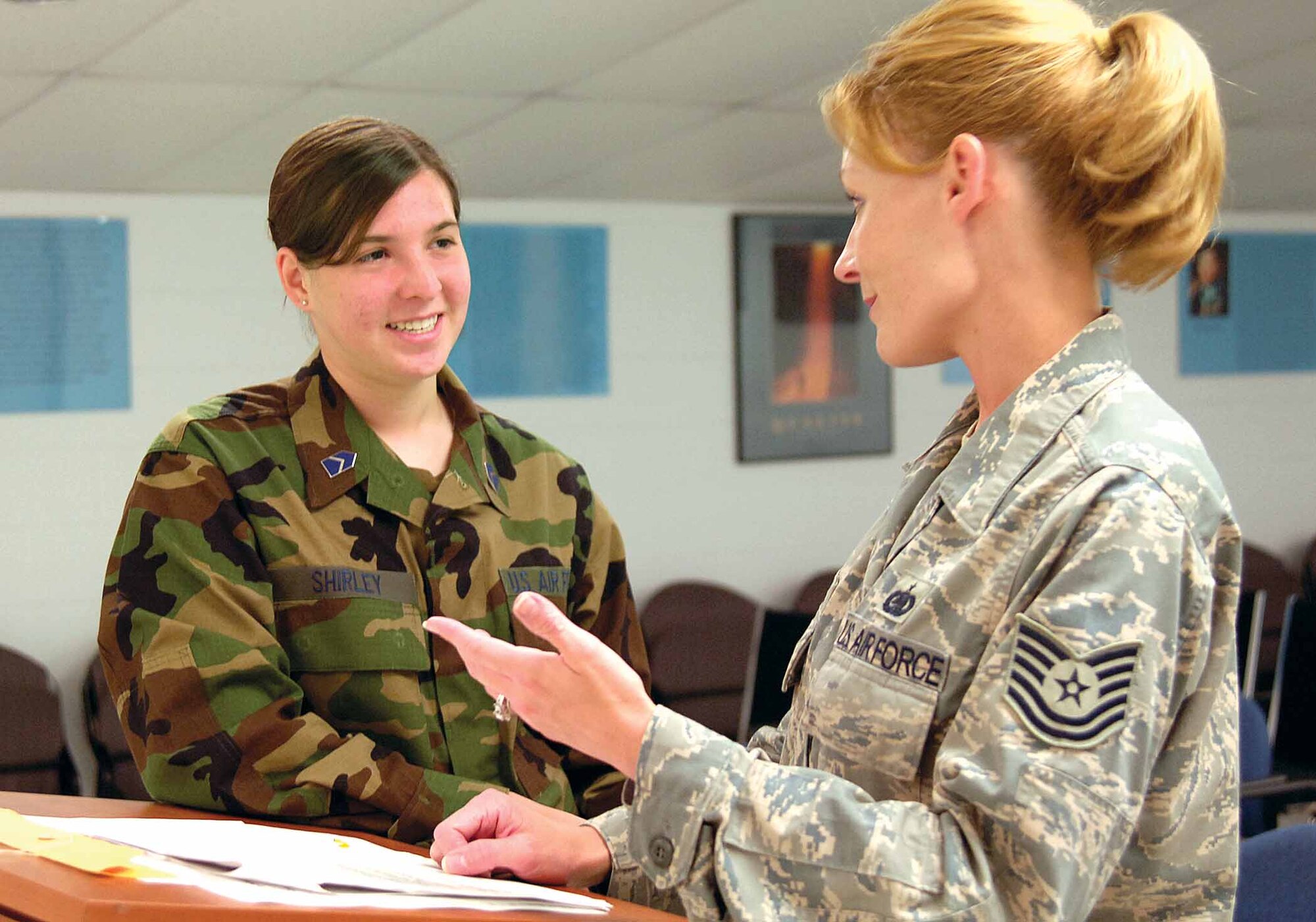 ROTC Cadet 4th Class Christine Shirley talks with Tech Sgt. Rachel Moore in the First Term Airmen Center Wednesday, more than halfway through the cadet’s three-week shadowing of the noncommissioned officer in charge of the center.  Operation Air Force brought 27 cadets out of the classroom and into the active Air Force to prepare them for leadership roles. Cadet Shirley, whose mother is a deployed Air Force master sergeant, is learning about training, life and leadership in the enlisted corps.  (Air Force photo by Margo Wright) 
