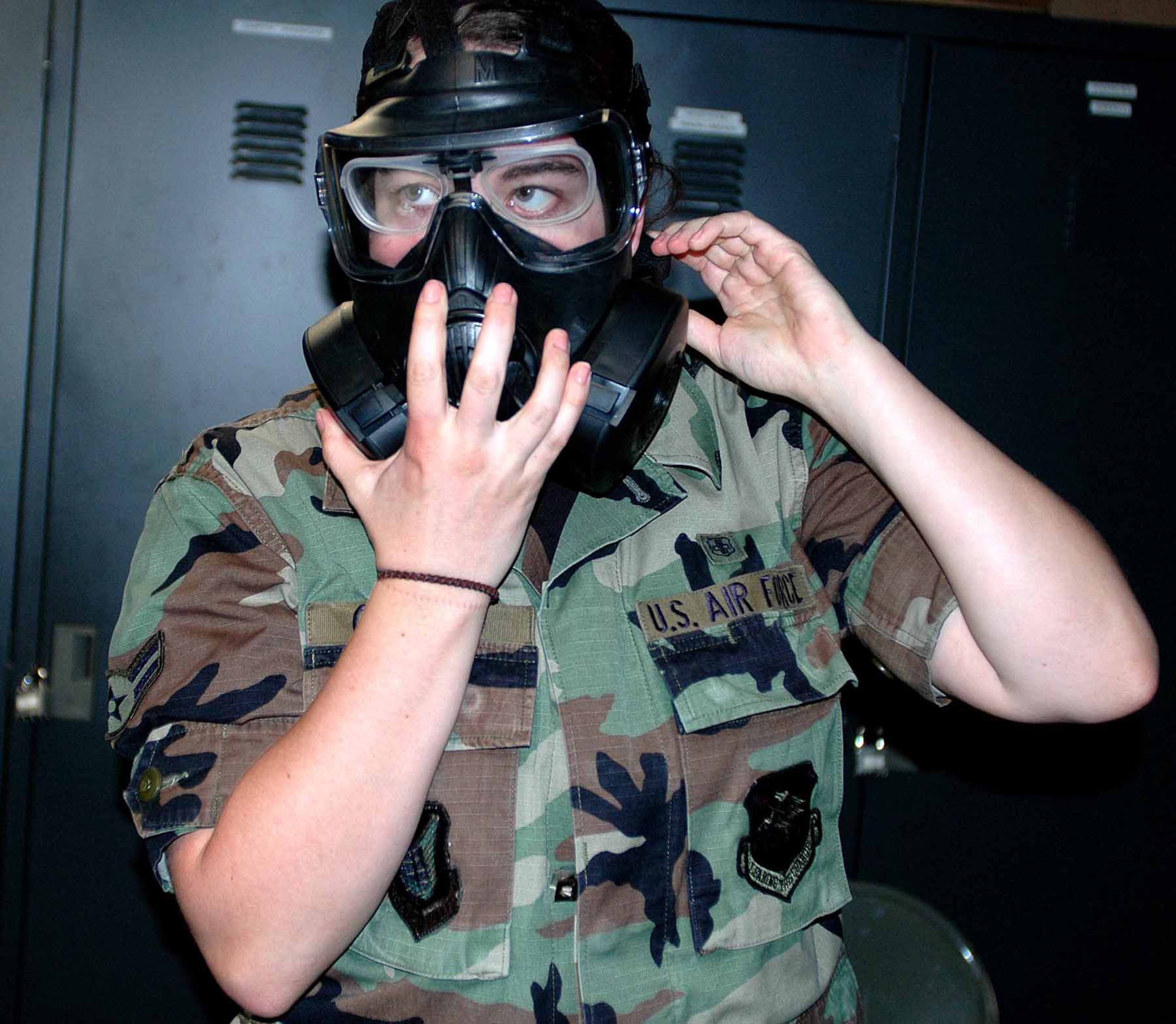 Airman 1st Class Sarah Gaylord dons her new M-50 protective mask during a training class June 9 at Osan Air Base, South Korea. The new mask offers the same level of protection against chemical, biological and radiological threats as the MCU 2, but takes advantage of technological advancements such as a wider view, easier access to the drinking tube and an additional filter. Airman Gaylord is with the 51st Medical Operations Squadron. (U.S. Air Force photo/Staff Sgt. Candy Knight) 
