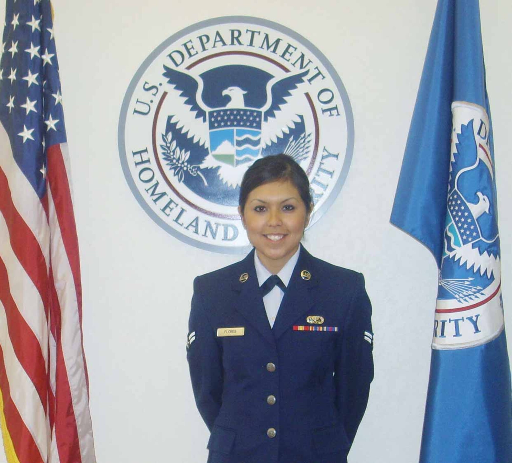 Airman Garza poses with “her” country’s flag after becoming a U.S. citizen in March.  (Air Force photo by Margo Wright