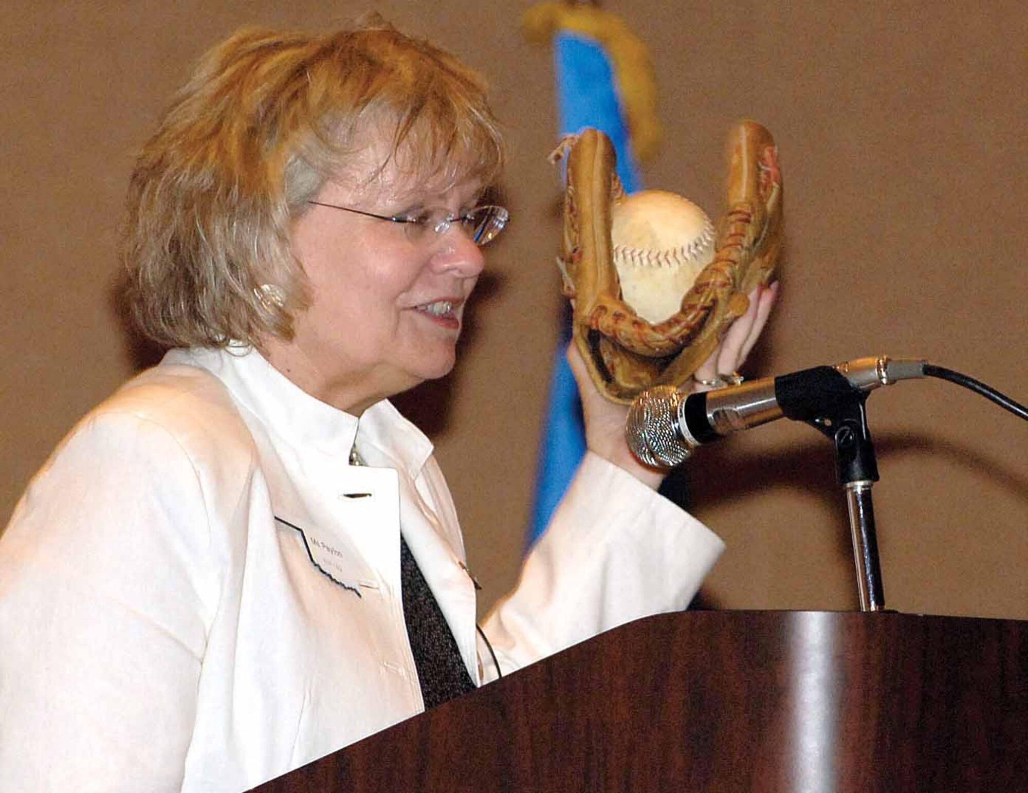 Sue Payton, entrusted with a $210 billion investment strategy as the Pentagon’s Assistant Secretary of the Air Force for Acquisition, uses a prized childhood softball and glove during an Air Force Services Acquisition Workshop speech to illustrate a point about being good stewards of taxpayers’ money.  Encouraged to save for the glove, she said her parents’ lessons parallel how Air Force acquisition professionals should protect the tax payers’ money and ensure the warfighter gets the best product possible  (Air Force photo by Margo Wright) 