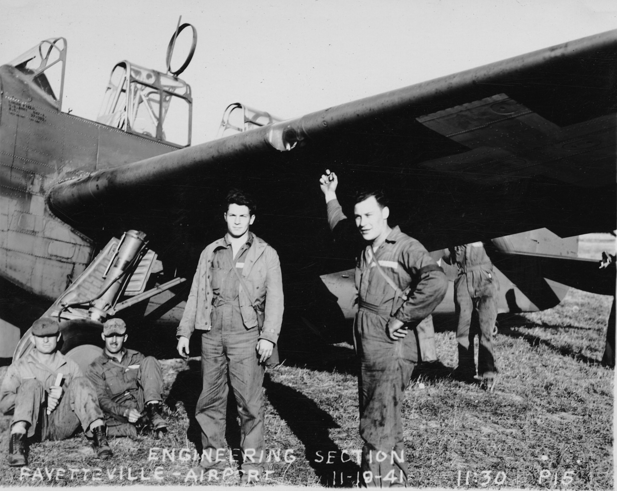 Maryland Guardsmen of the 104th Observation Squadron's Engineering Section take a break under the wing of one of the squadron's O-47 aircraft during training at Fayetteville Airport, N.C., Nov. 19, 1941. The unit, along with the rest of the Maryland National Guard, had been mobilized in February in anticipation of World War II.