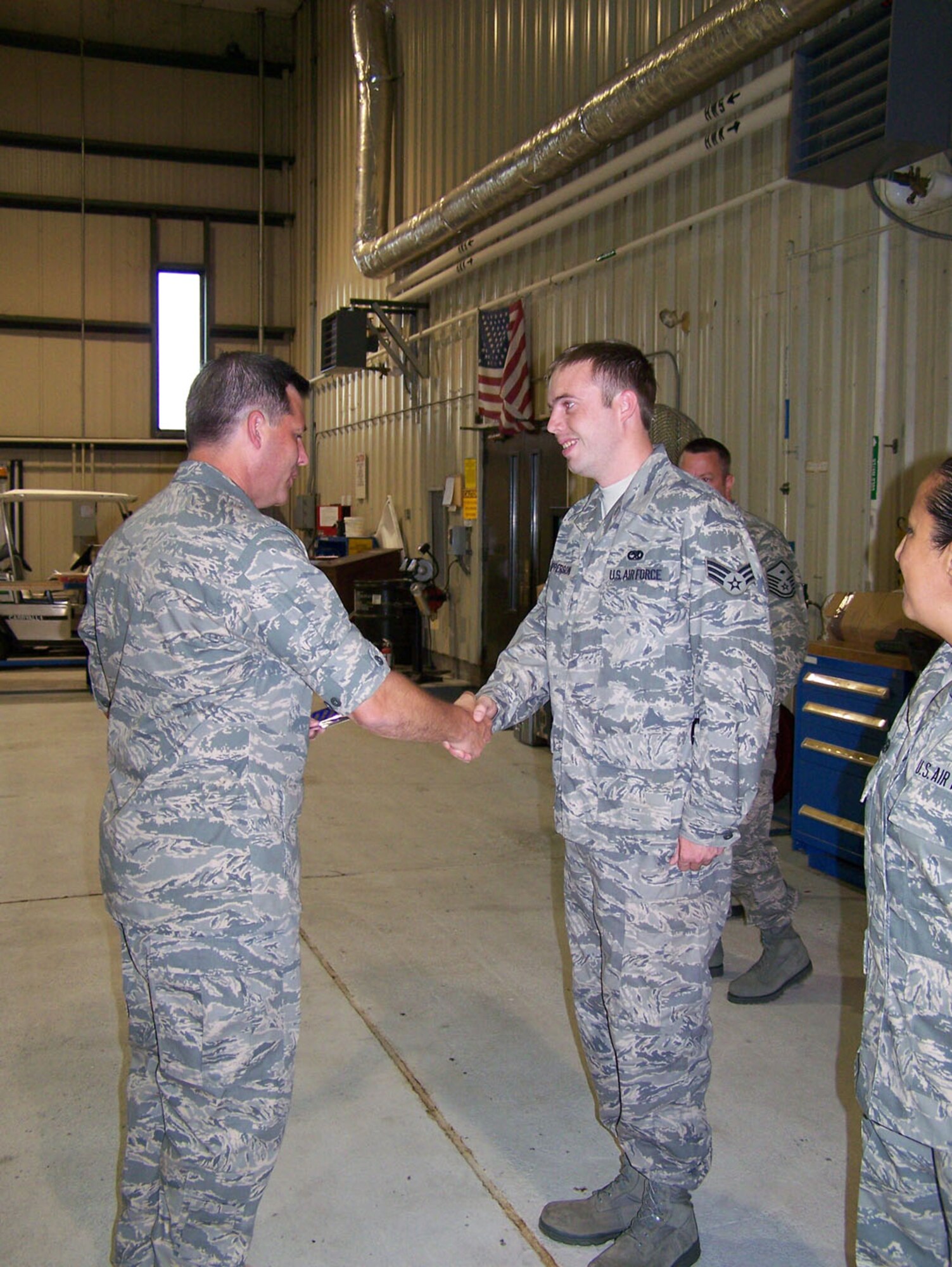 SEYMOUR JOHNSON AIR FORCE BASE, N.C. -- Reservist Rodney Apperson (right) is congratulated by Lt. Col. James Shealy on his promotion to staff sergeant. Sgt. Apperson is assigned to the 916th Maintenance Group as an aircraft fuel systems technician.