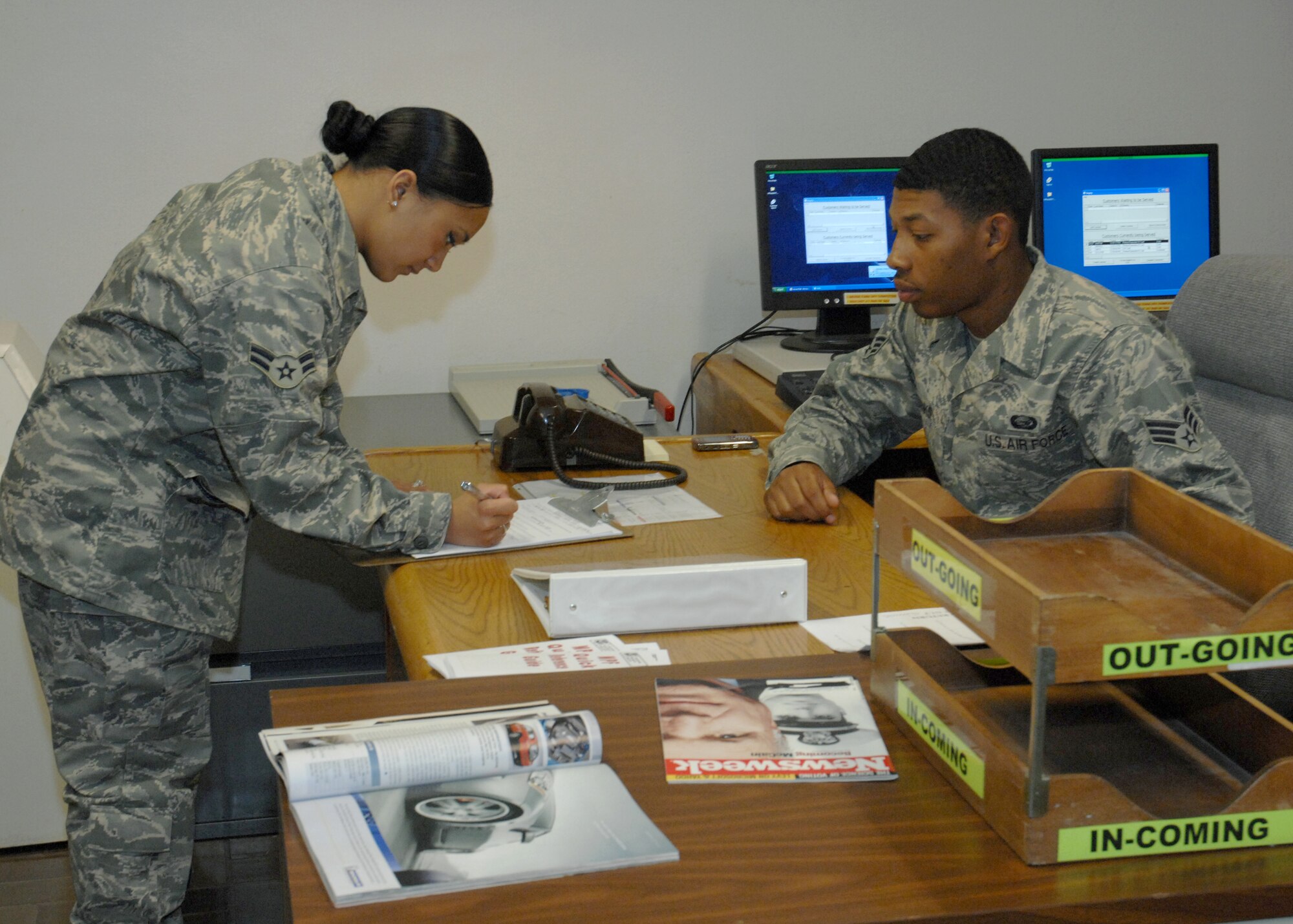 CANNON AIR FORCE BASE, N.M.- Commando Care Center (CCC) Representative Senior Airman Derick Banks assists Airman 1st Class Valerie Barbarino fill out her re-enlistment file June 11. The new CCC opens up a possibility of personnel consolidation, introducing a new "one stop shopping" location.(U.S. Air Force photo by Airman Maynelinne De La Cruz)