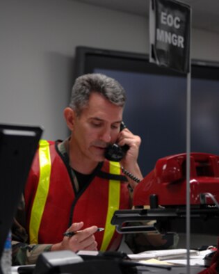 WHITEMAN AIR FORCE BASE, Mo., - Lt. Col. Stephen Thompson, 509th Mission Support Group commander and Emergency Operation Center manager takes a phone call during an exercise scenario. (U.S. Air Force photo/Senior Airman Jessica Snow)